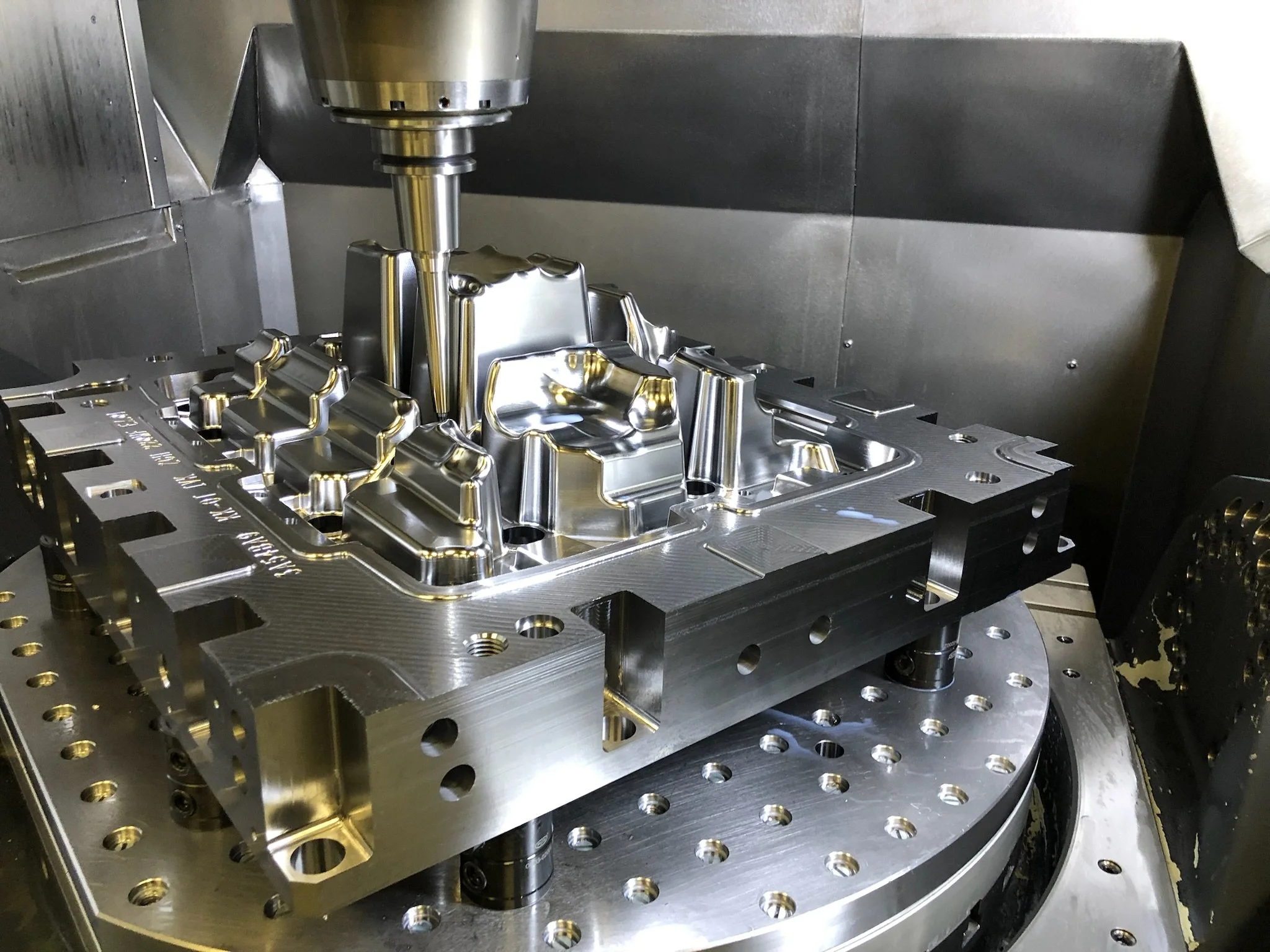 Stählerner Werkstück auf einer industriellen Maschine, vermutlich für die Fertigung oder Bearbeitung in der Produktion