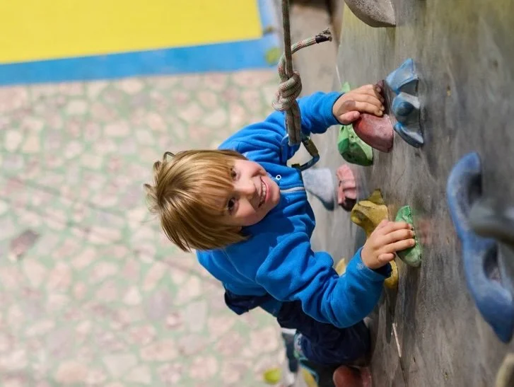 Boy climbing rock wall