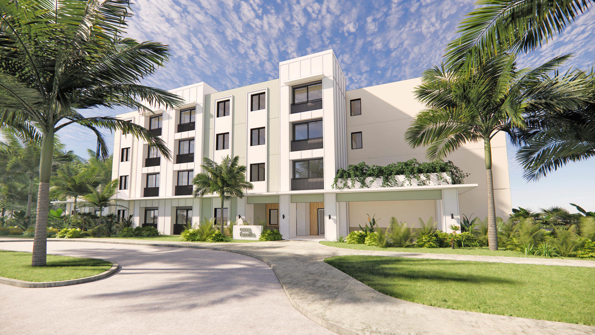 Modern multi-story apartment building with white exterior walls and large windows, surrounded by palm trees and lush landscaping, under a partly cloudy sky.