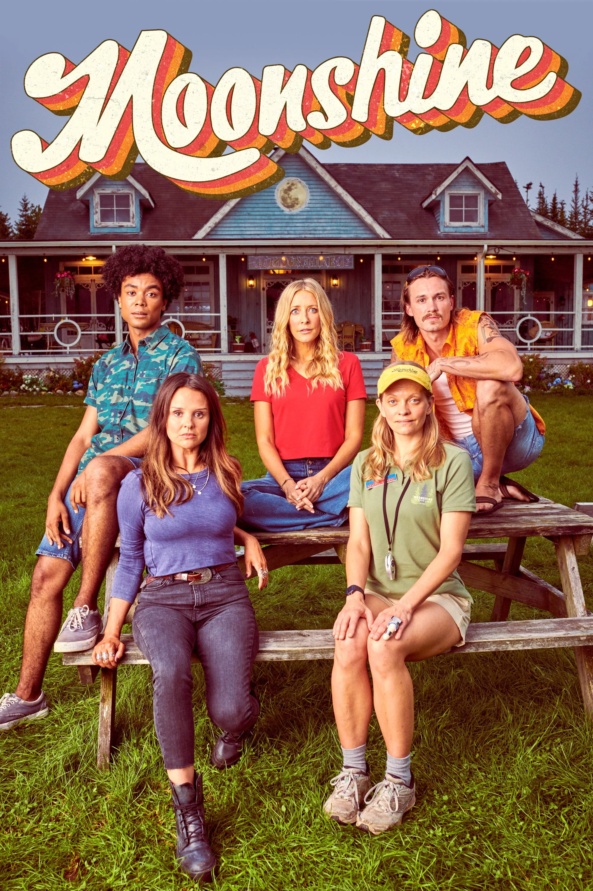 Promotional poster for the TV show 'Moonshine' featuring five characters sitting on a picnic table in front of a house with a large moon in the sky.
