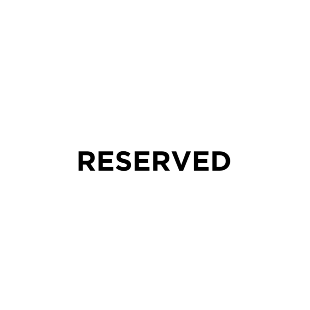 A white sign with black bold text that reads "RESERVED."