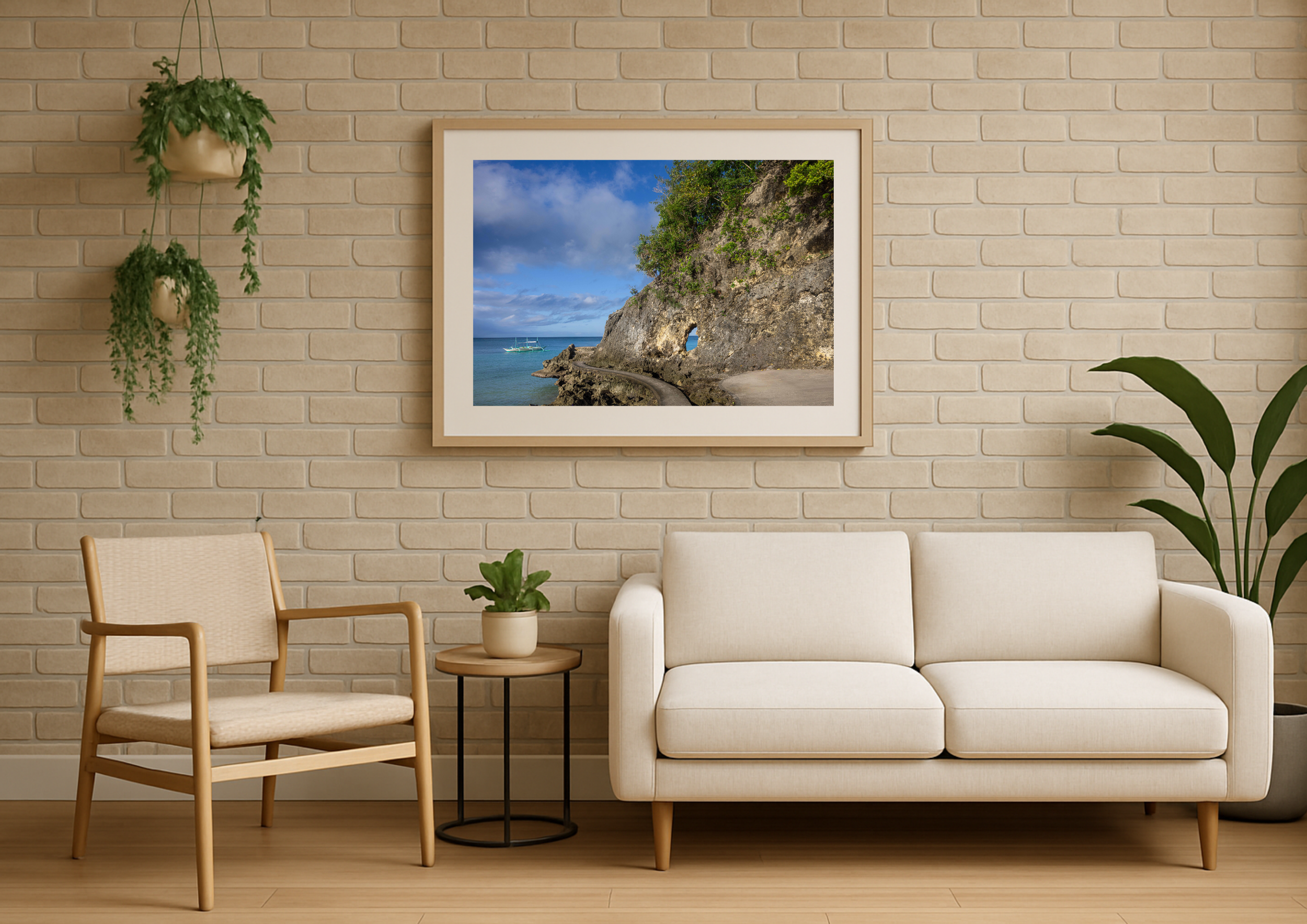 Living room with a framed beach landscape on a brick wall, green plants hanging and sitting, beige and light brown furniture, wooden floor.