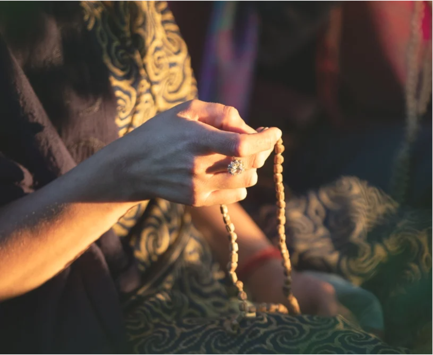 Woman with japa mala prayer beads during OM chanting or mantra meditation – Spark Healing Toronto & Playa del Carmen
