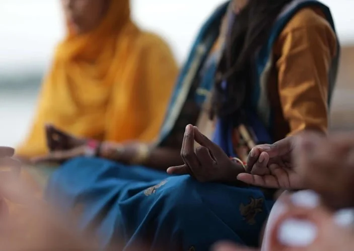 People in lotus pose meditating outdoors – mindfulness group retreat Spark Healing Toronto & Playa del Carmen
