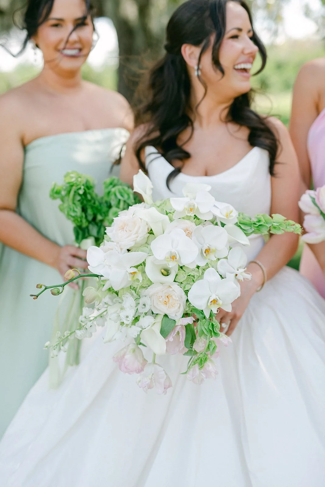 bride-laughing-cascading-orchid-rose-bouquet-bridesmaids-tampa-wedding.jpg