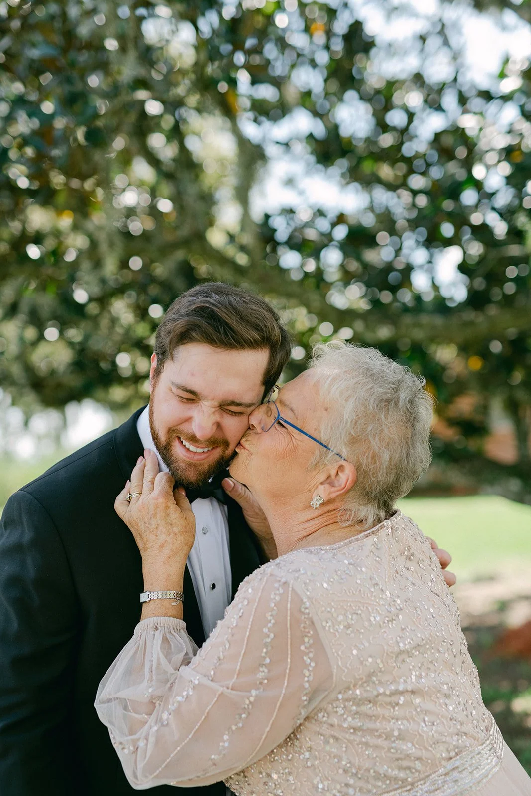 groom-grandmother-kiss-live-oak-tree-tampa-wedding-emotional-moment.jpg