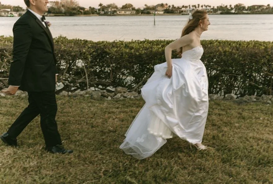 bride-groom-running-waterfront-golden-hour-sunset-tampa-bay-wedding.jpg