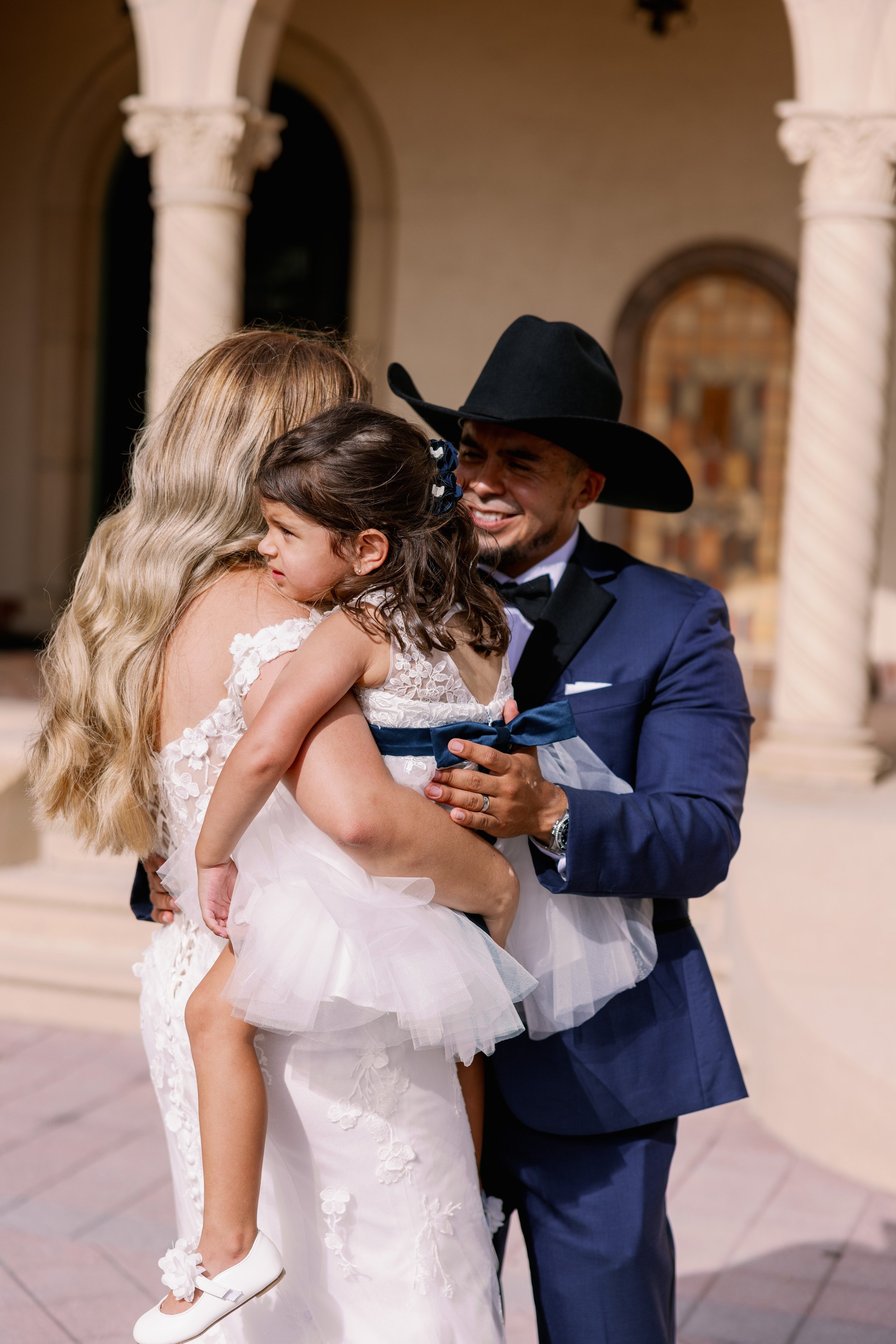 bride-groom-cowboy-hat-embrace-balcony-powel-crosley-estate-wedding-planner-sarasota.jpg