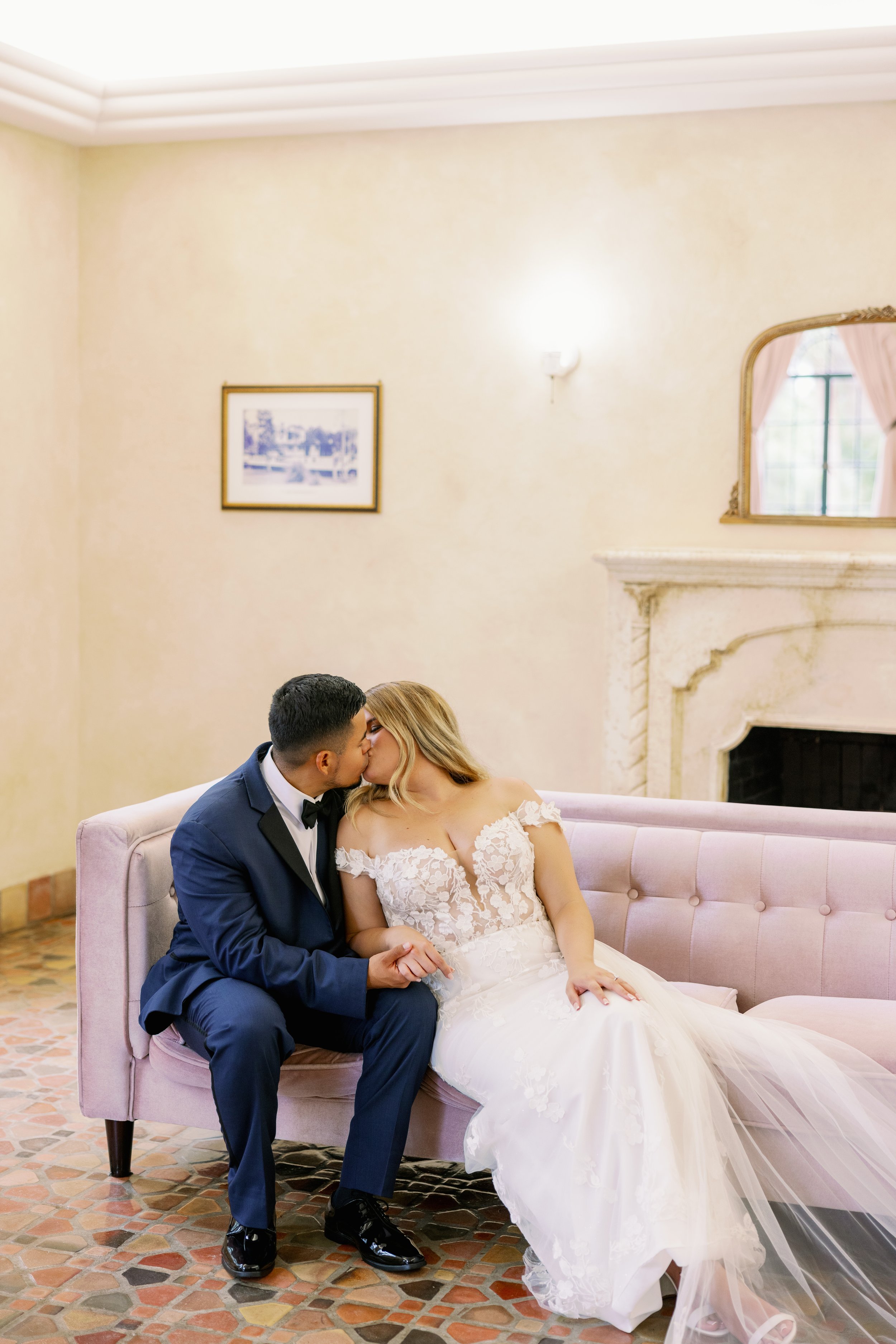 bride-groom-laughing-pink-sofa-bridal-suite-powel-crosley-estate-wedding-sarasota.jpg