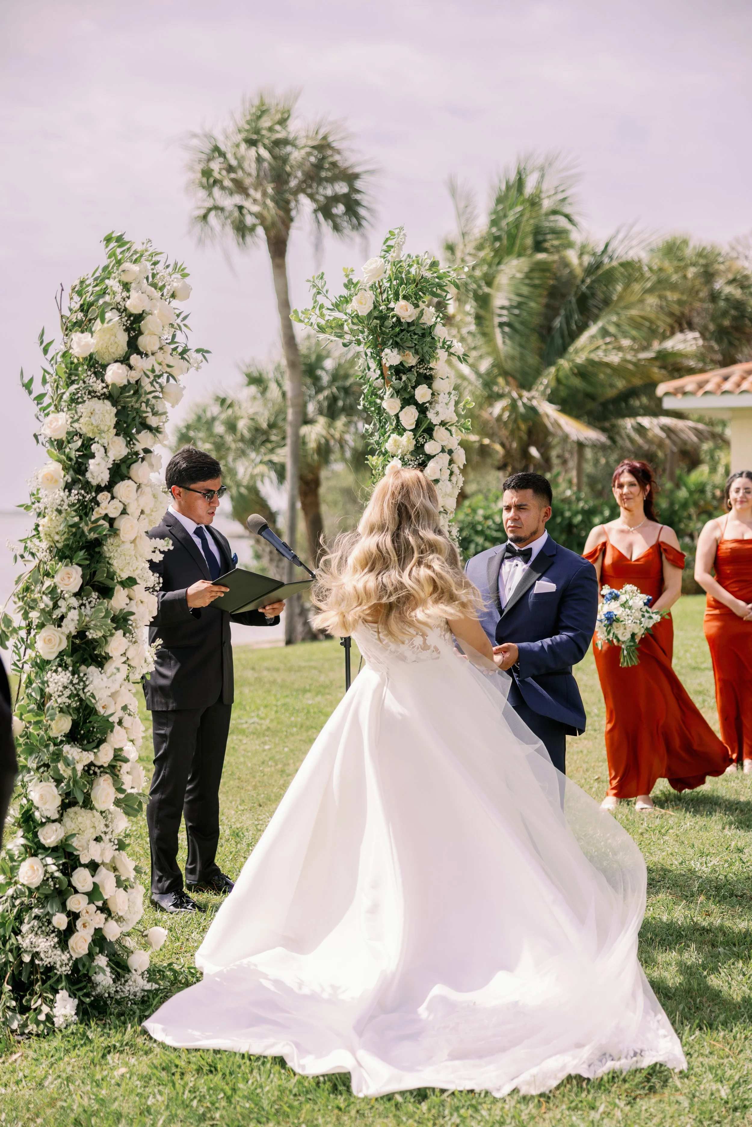 bride-groom-vow-exchange-floral-arch-groomsmen-powel-crosley-estate-wedding-sarasota.jpg