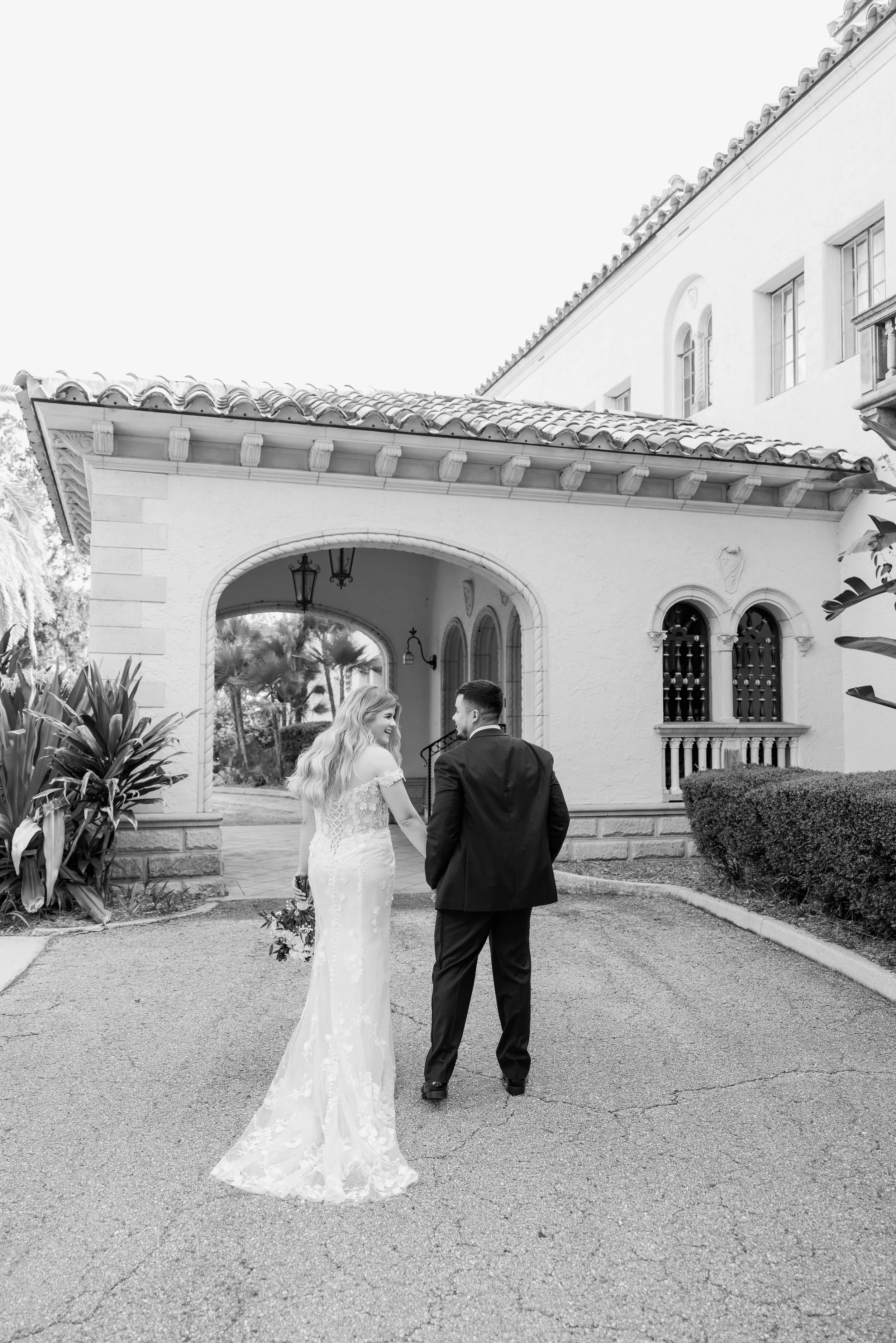 bride-groom-walking-together-black-and-white-powel-crosley-estate-wedding-planner-sarasota.jpg