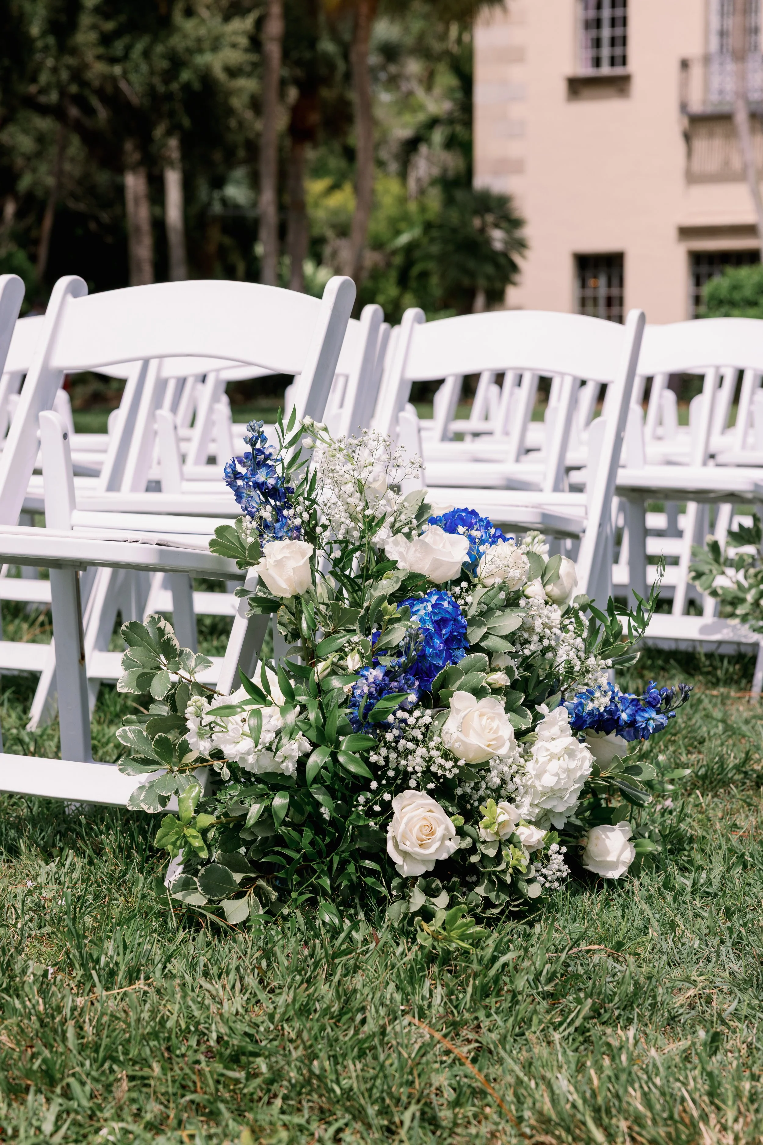 ceremony-aisle-floral-detail-white-chairs-powel-crosley-estate-wedding-planner-sarasota.jpg