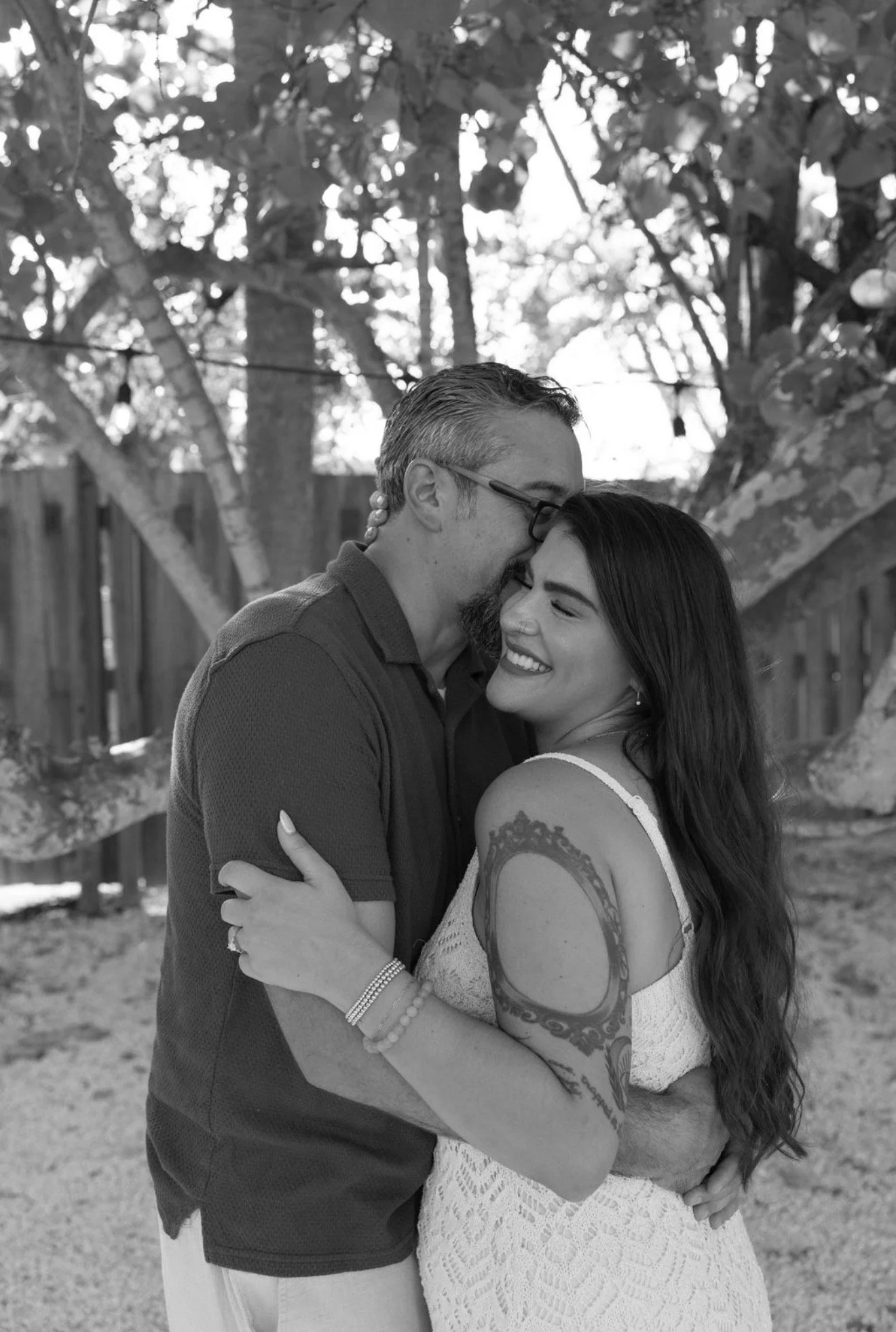 couple-embrace-candid-greenery-anna-maria-island-wedding-weekend.png