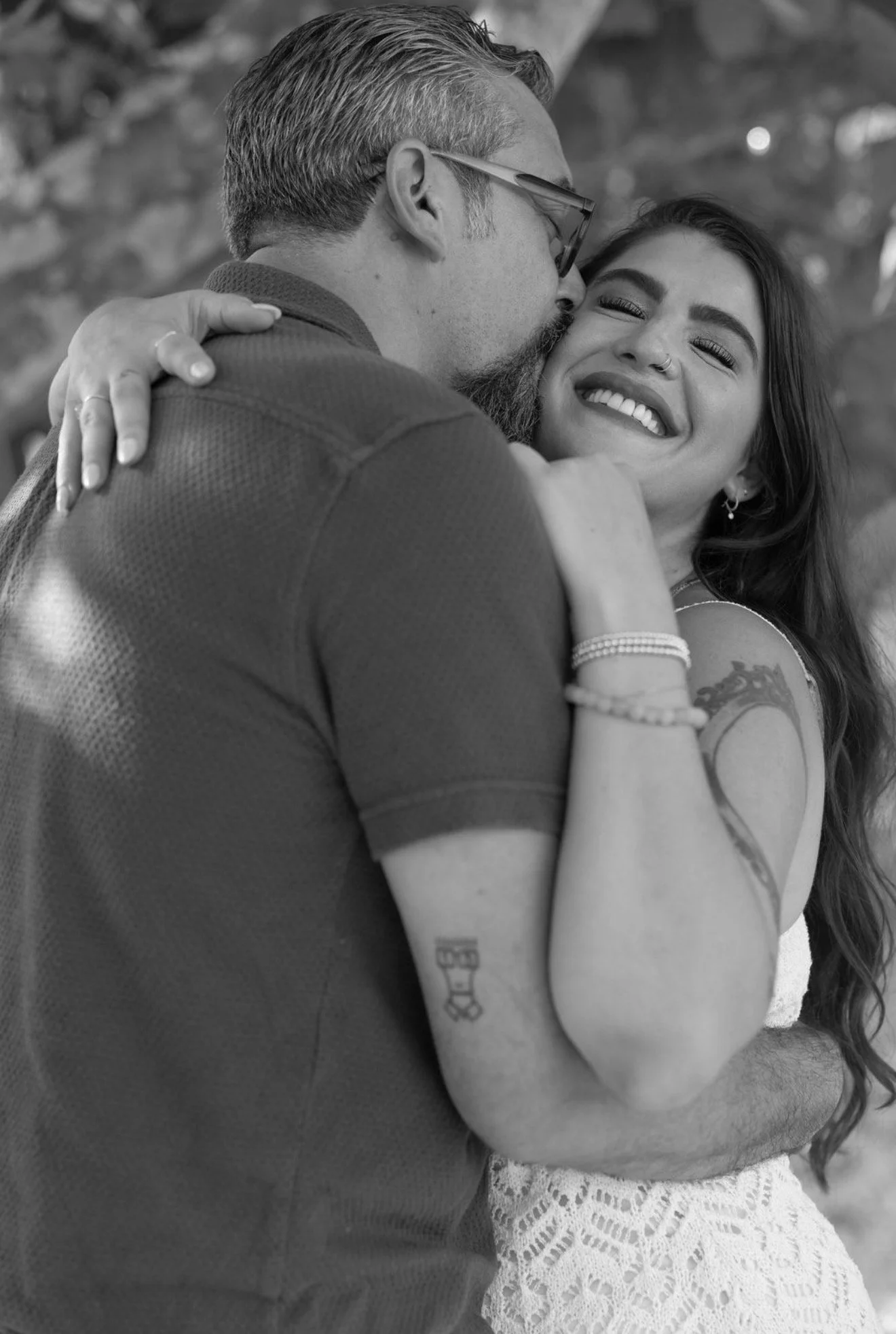 couple-laughing-cheek-to-cheek-black-and-white-anna-maria-island-wedding-weekend.png