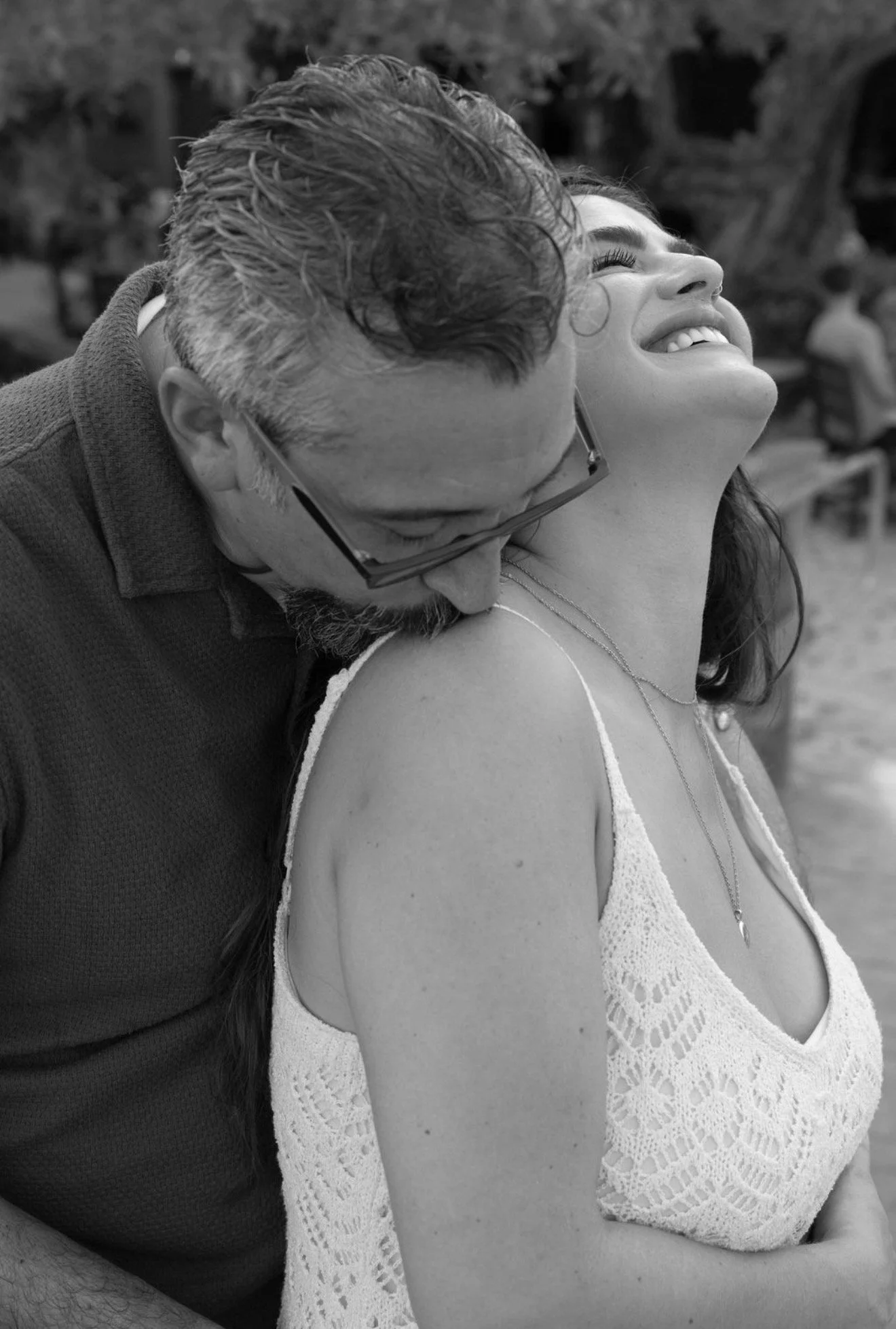 couple-laughing-embrace-black-and-white-anna-maria-island-wedding-weekend.png