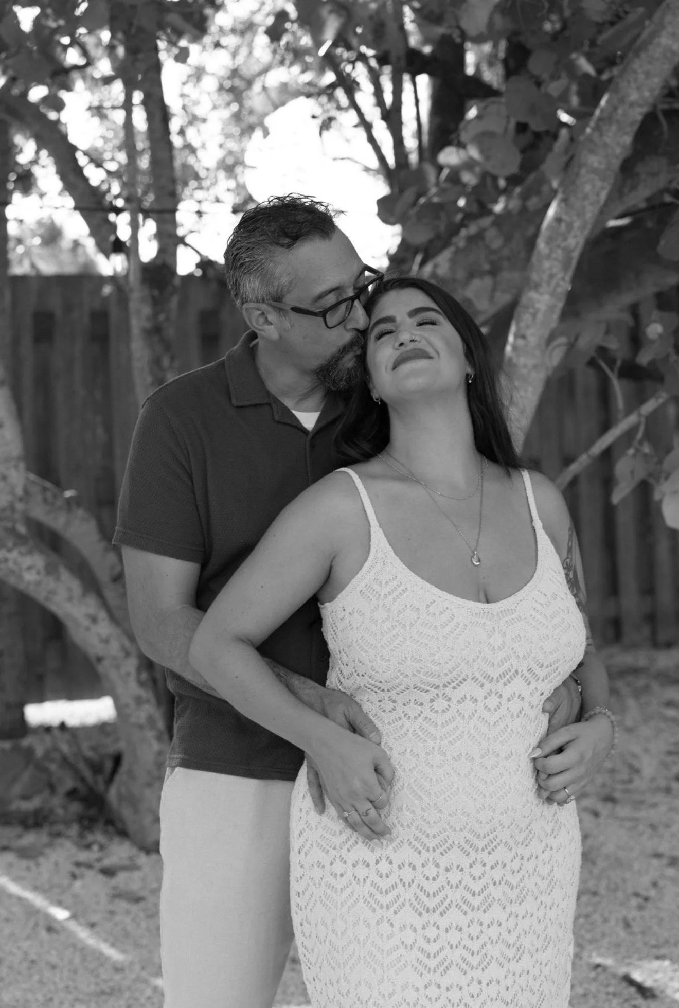 couple-laughing-playful-black-and-white-anna-maria-island-wedding-weekend.png