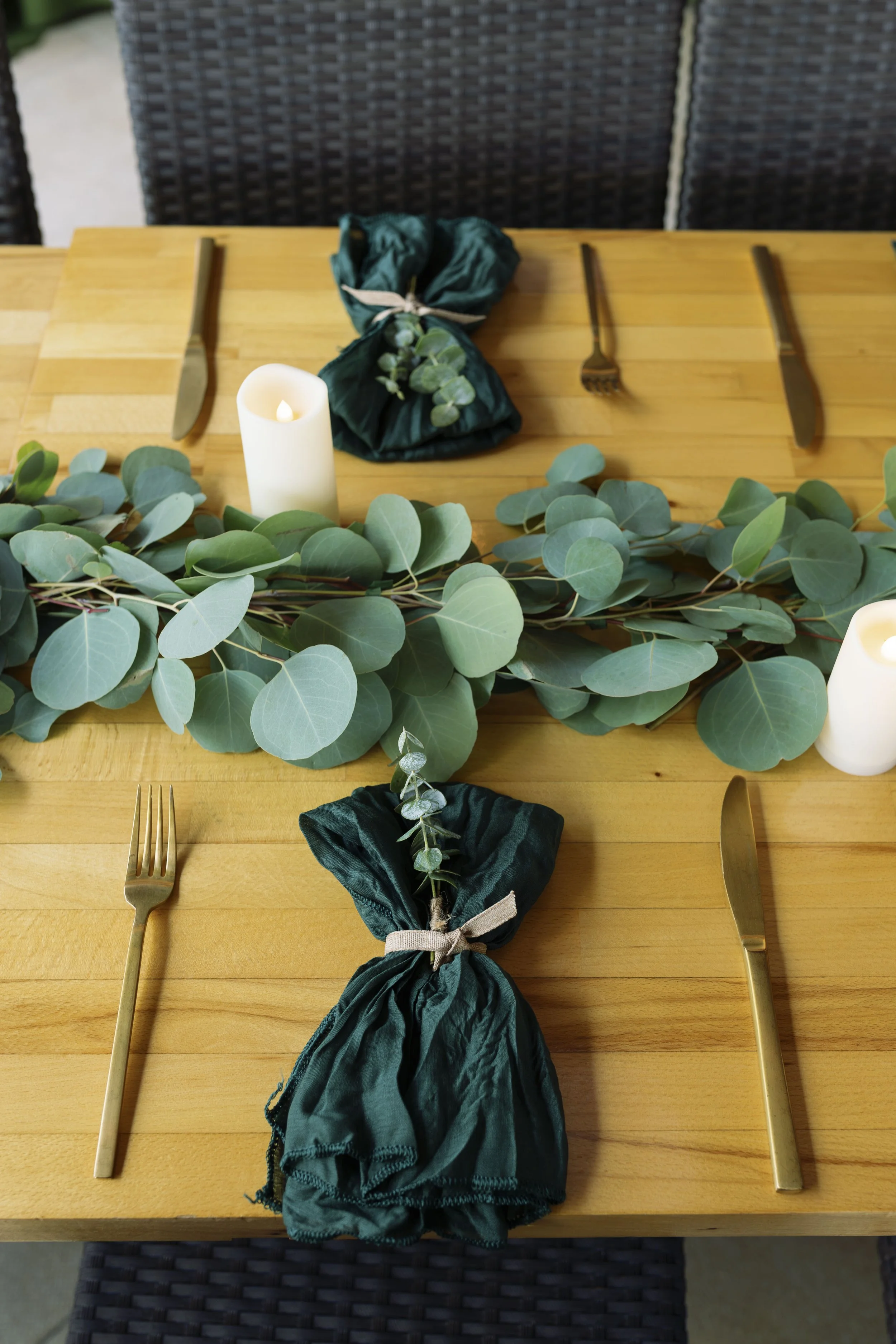 wooden-table-candles-eucalyptus-runner-gold-flatware-mar-vista-dockside-welcome-dinner-wedding.jpg