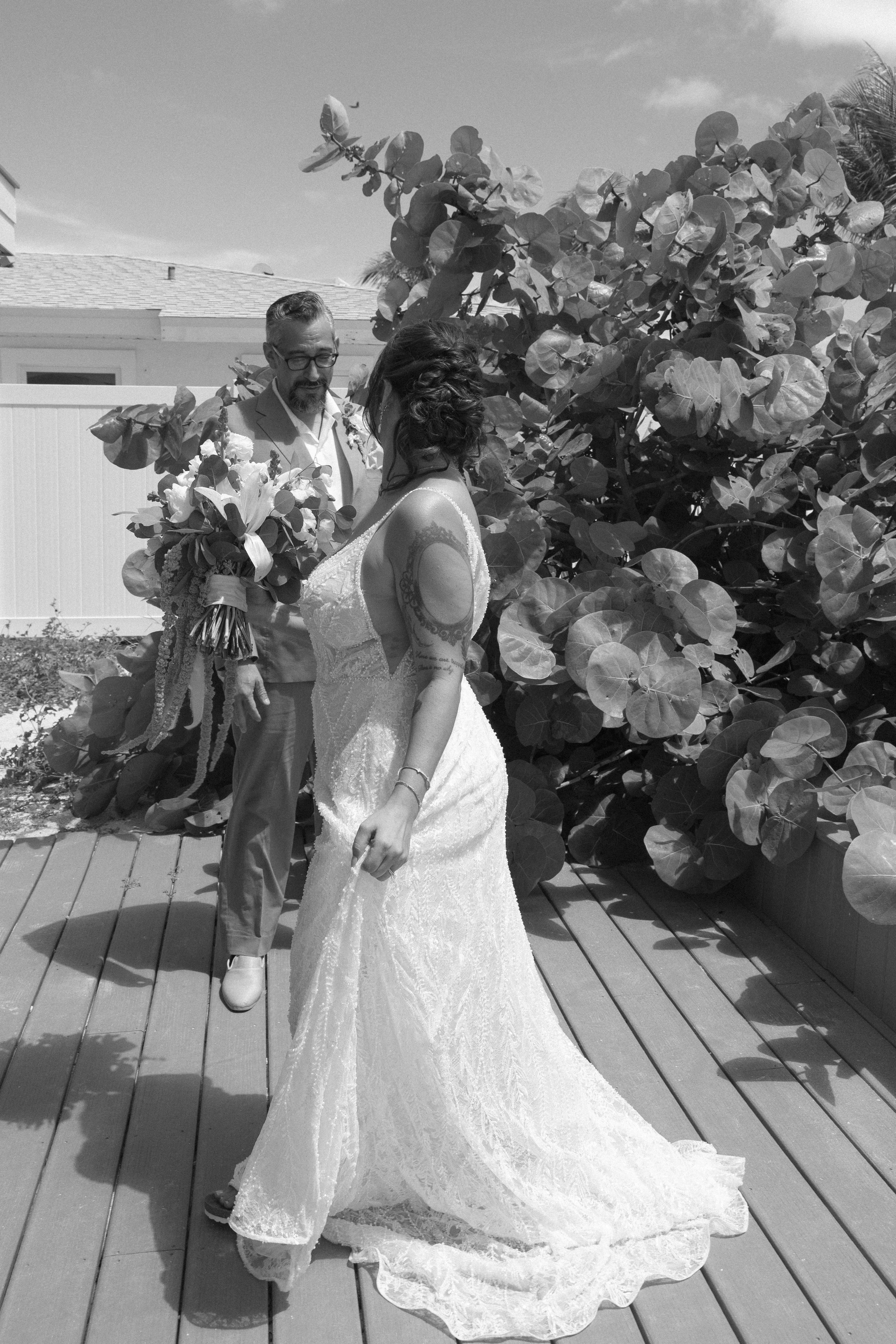 bride-father-embrace-black-and-white-grand-pavilion-sandbar-wedding.jpg