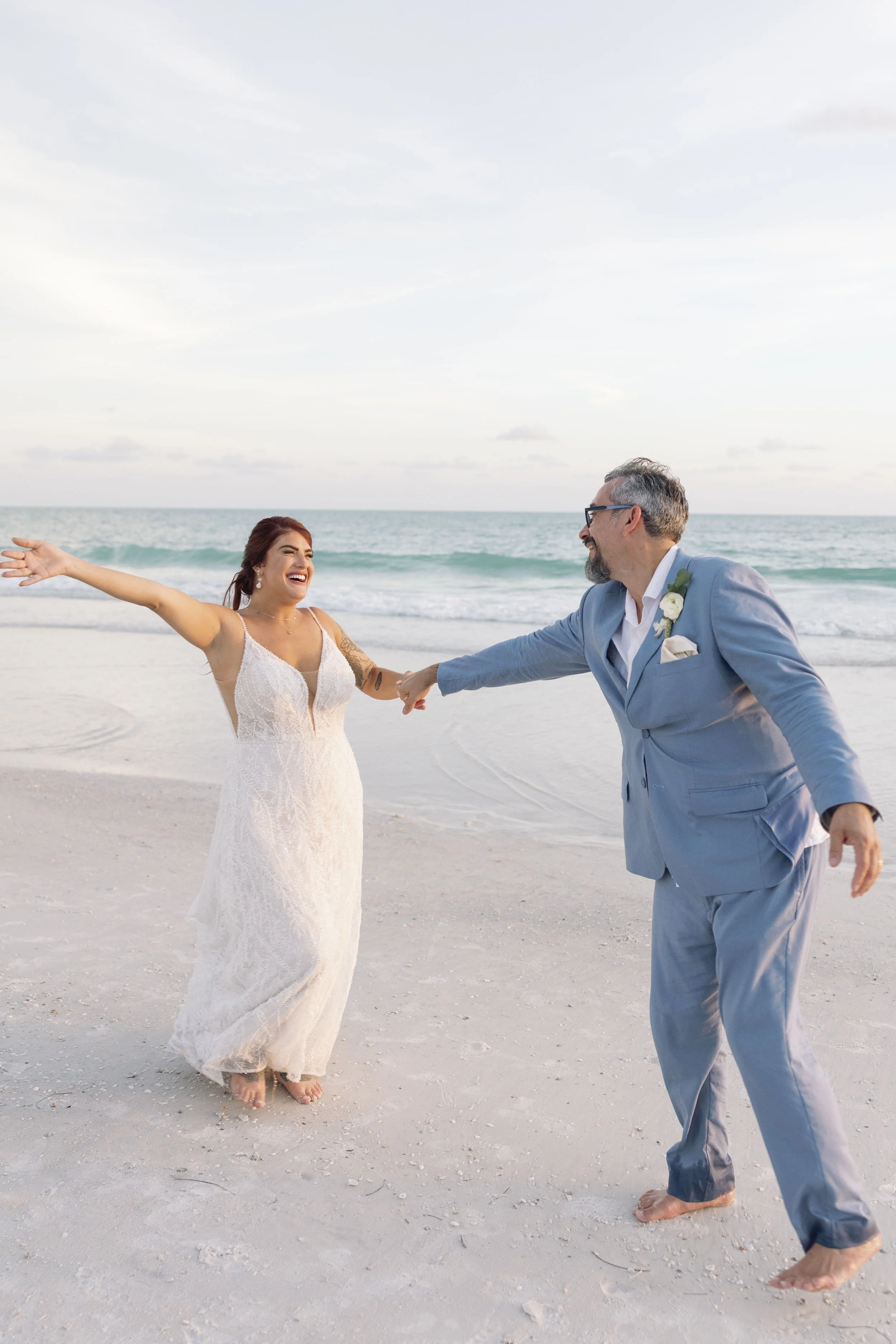 bride-groom-dancing-walking-beach-grand-pavilion-sandbar-anna-maria-island-wedding.jpg