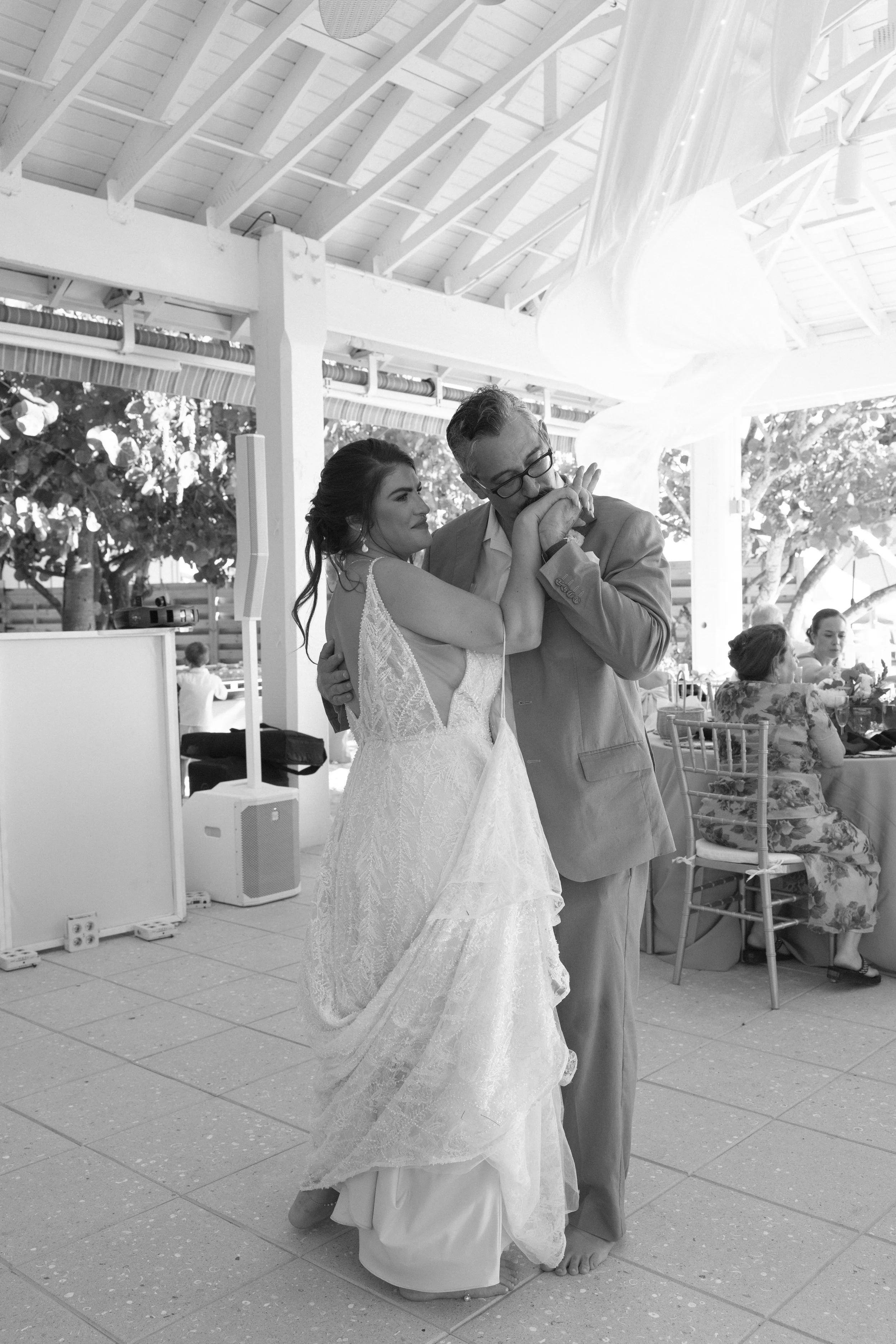 bride-groom-slow-dance-guests-watching-grand-pavilion-sandbar-wedding.jpg