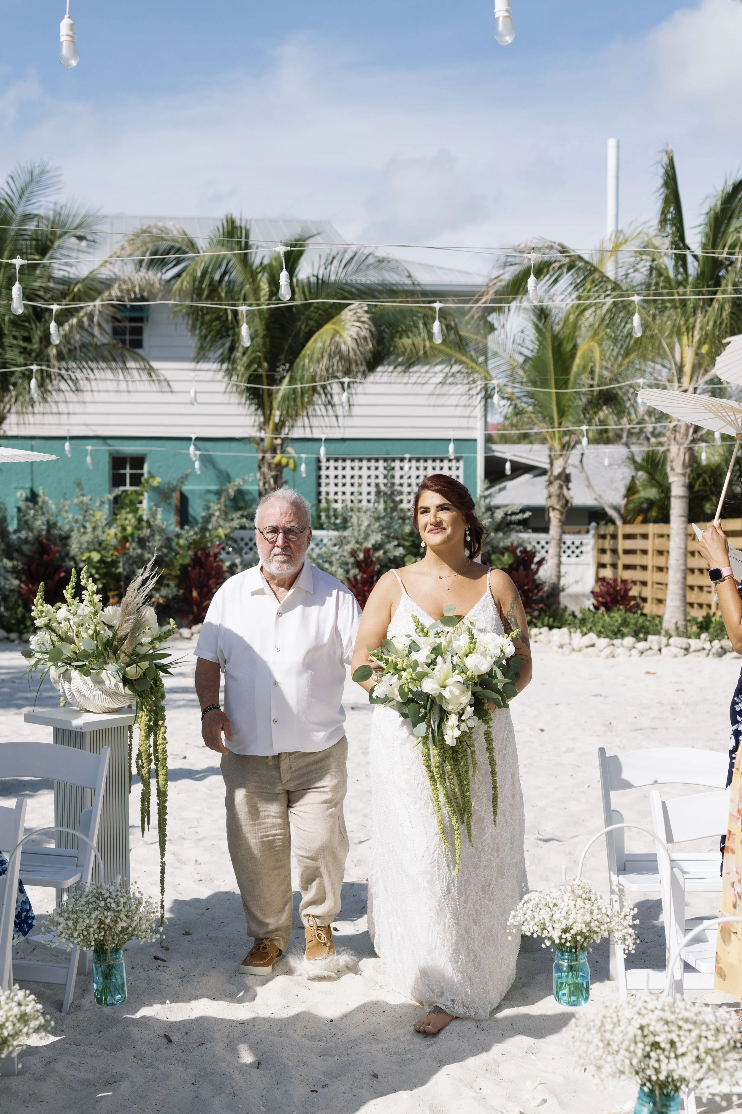 bride-groom-walking-beach-full-length-grand-pavilion-sandbar-anna-maria-island-wedding.jpg