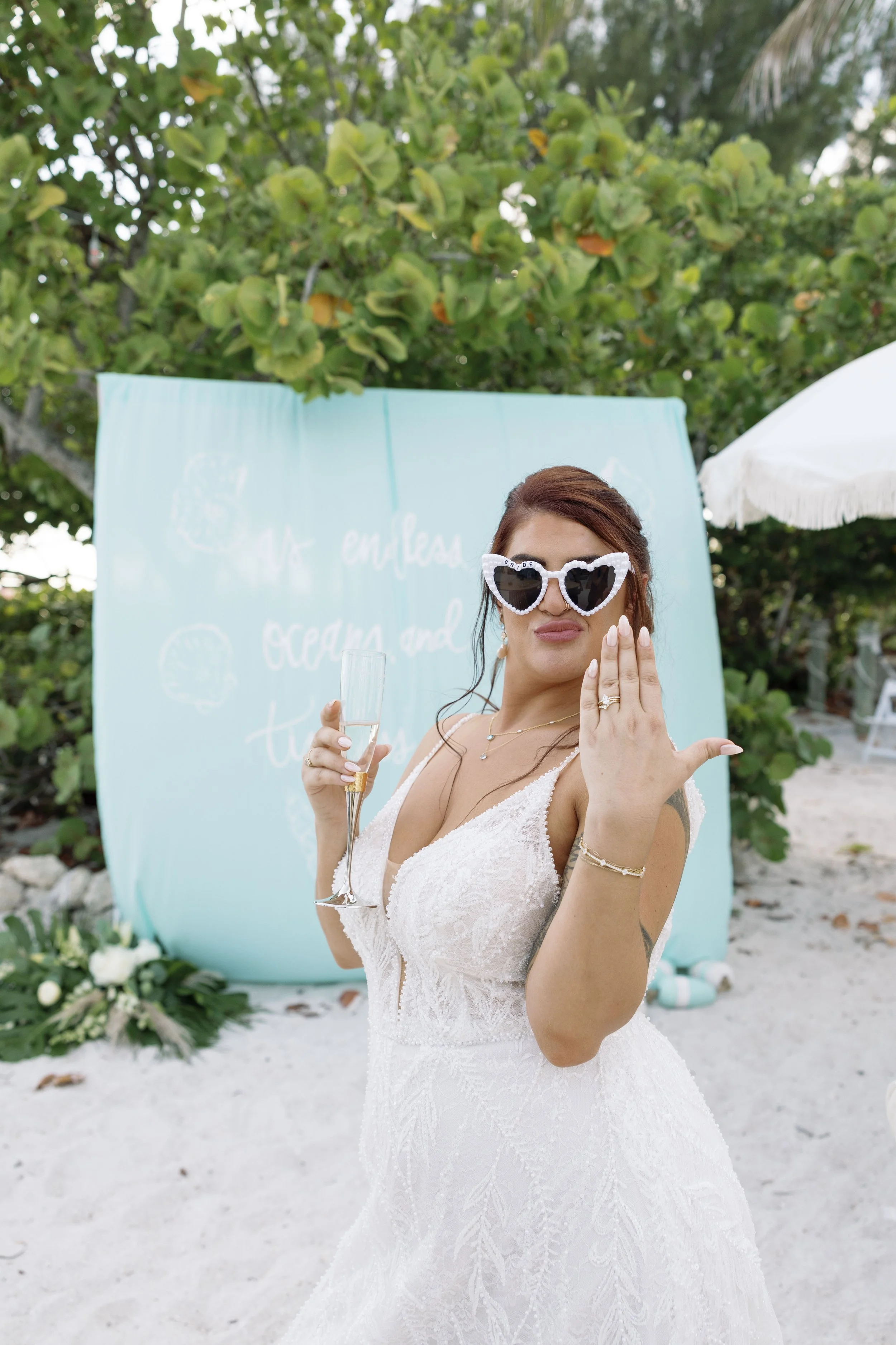 bride-solo-portrait-sunglasses-beach-candid-grand-pavilion-sandbar-wedding.jpg