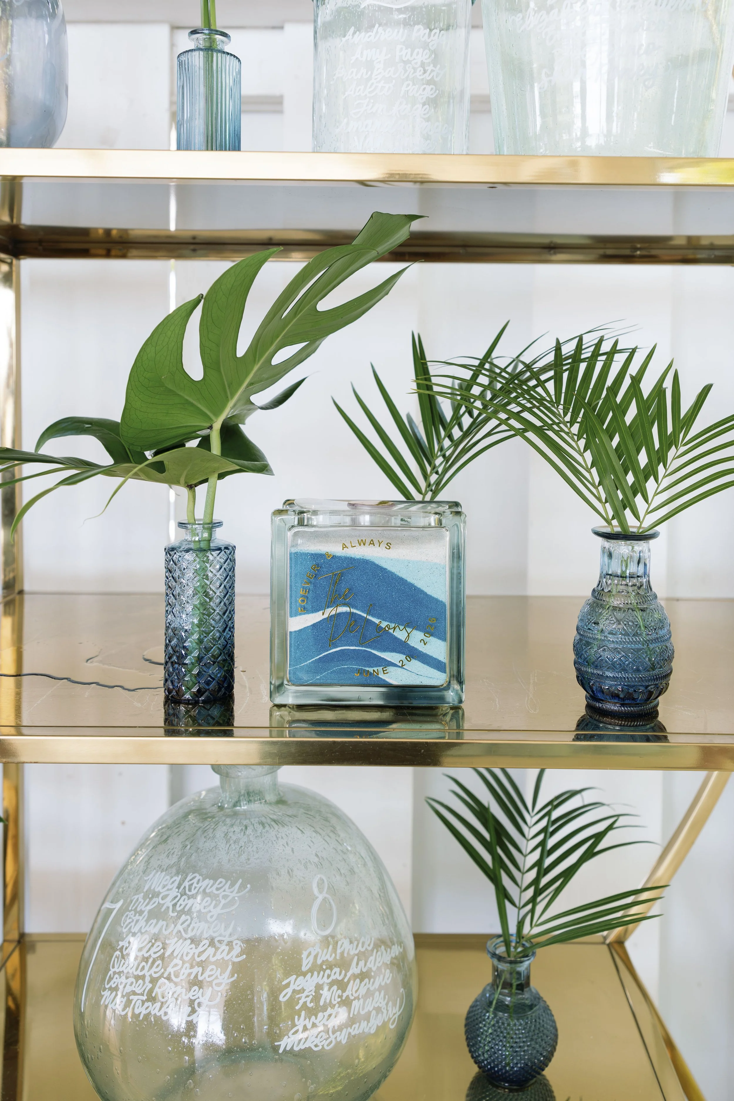 decor-shelf-vases-greenery-blue-white-grand-pavilion-sandbar-wedding.jpg