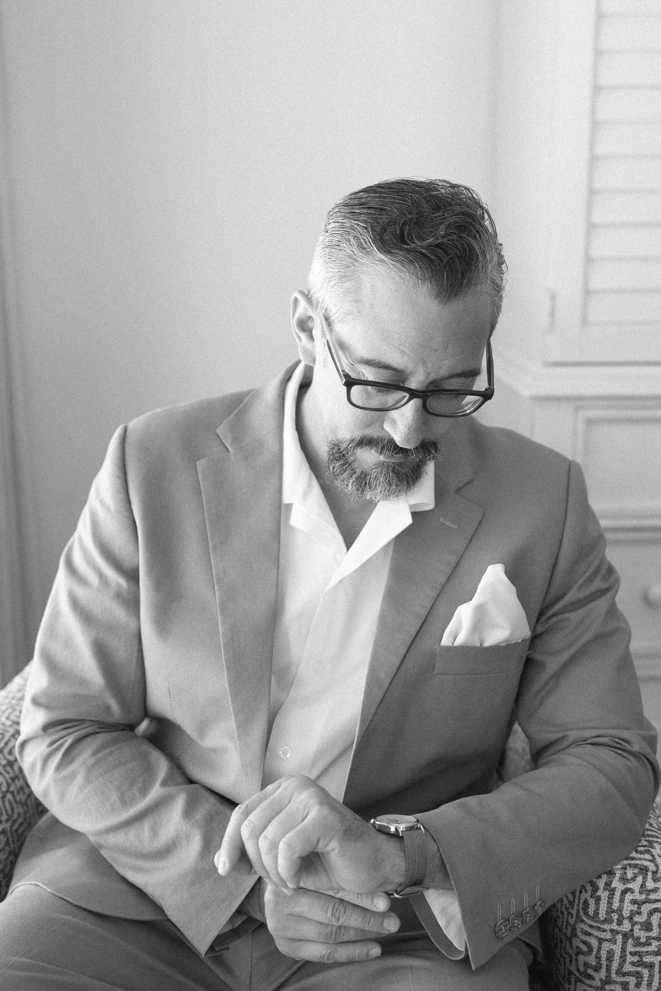 groom-adjusting-cufflinks-getting-ready-anna-maria-island-wedding.jpg