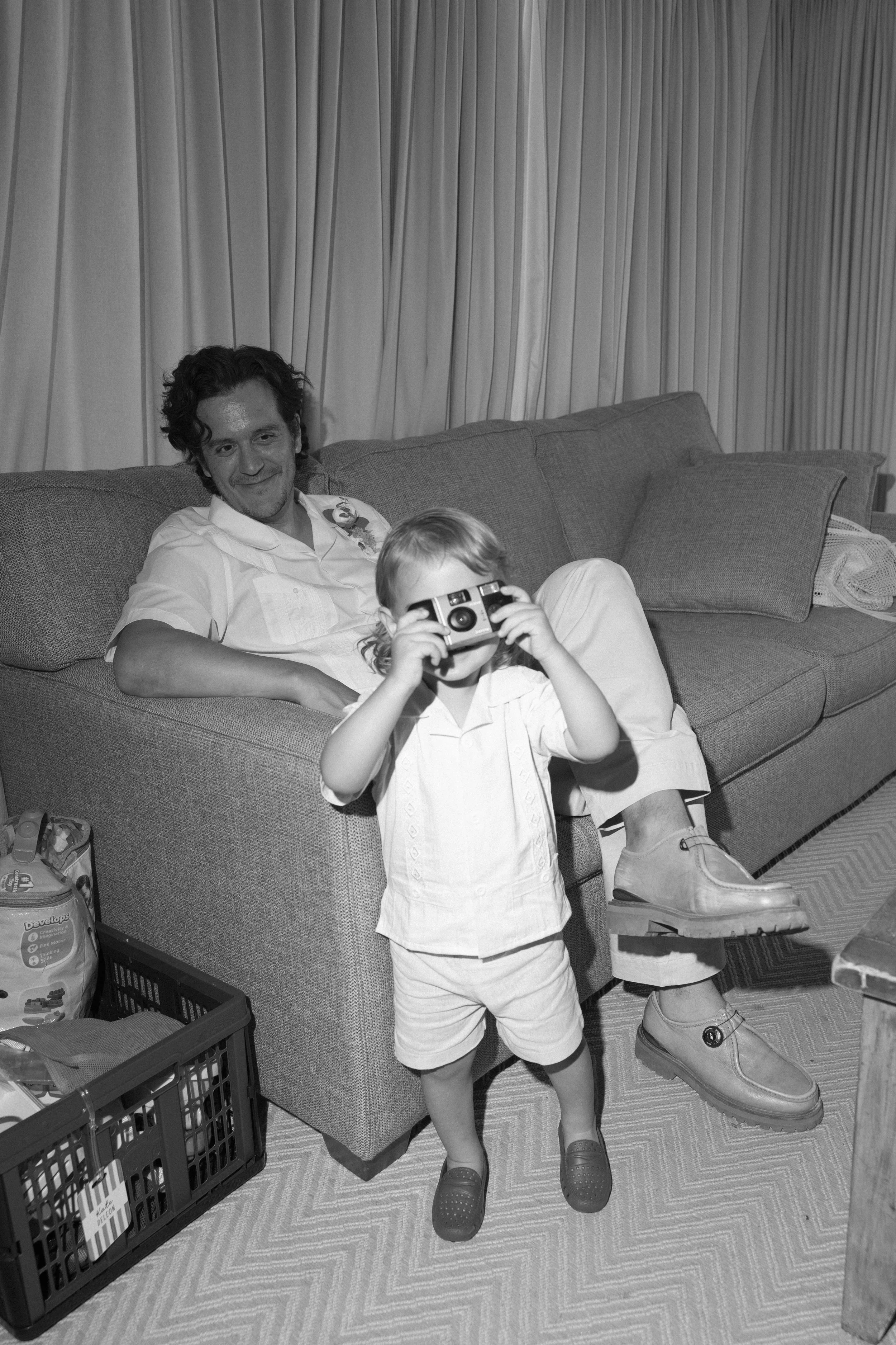 groom-with-child-candid-black-and-white-mainsail-inn-anna-maria-island-wedding.jpg