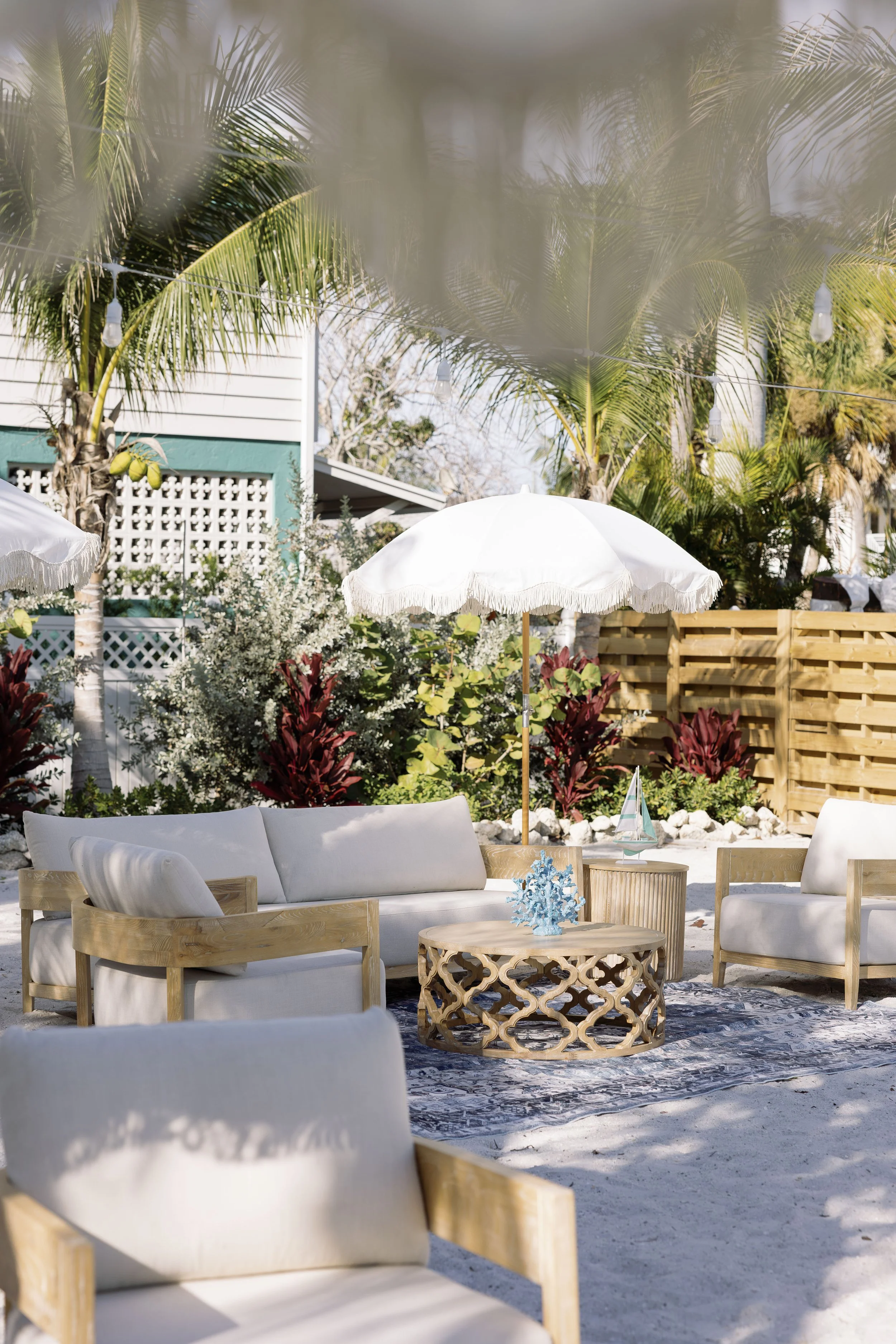 lounge-furniture-blue-coral-driftwood-decor-grand-pavilion-sandbar-wedding.jpg