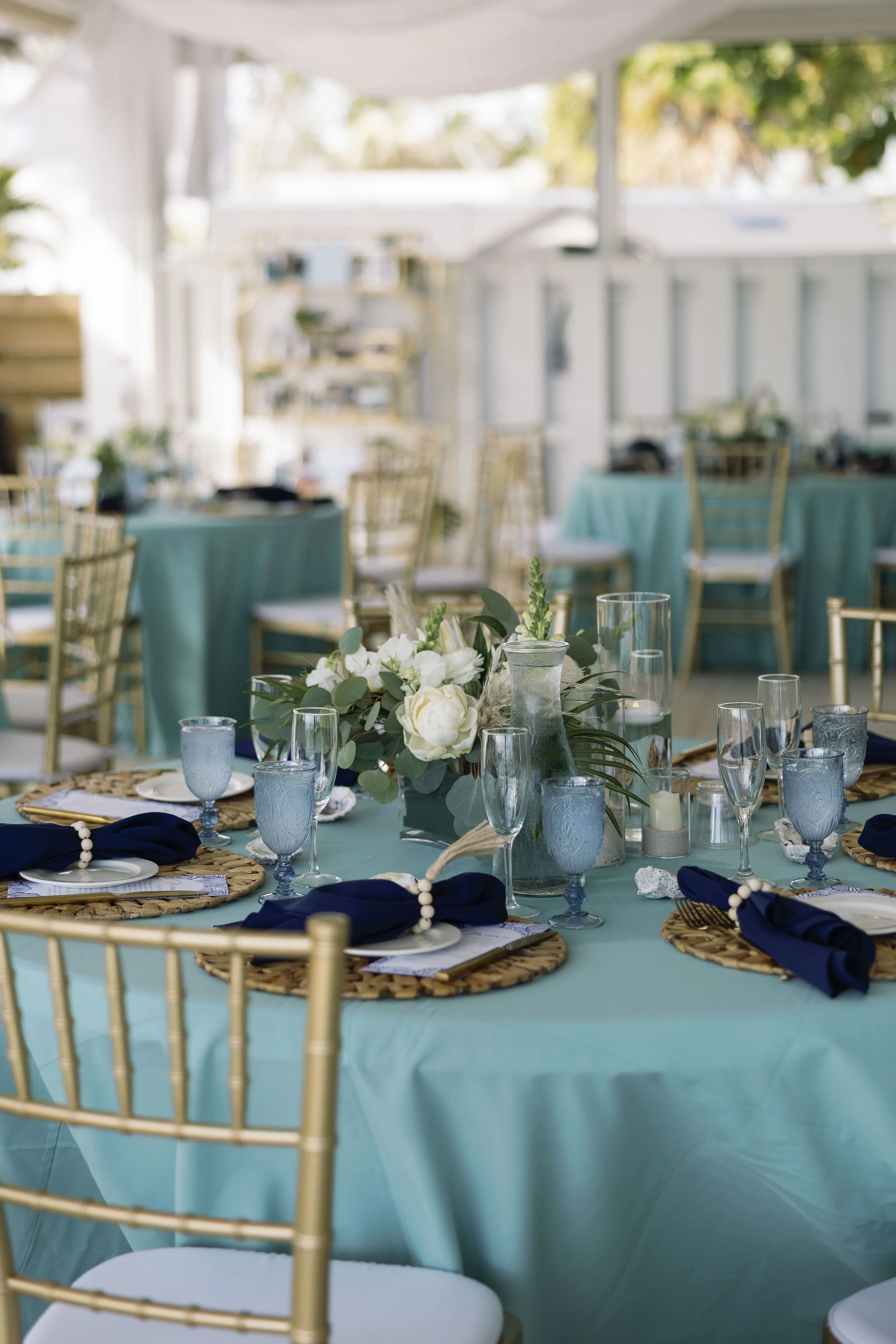 reception-tablescape-blue-linens-gold-chairs-grand-pavilion-sandbar-wedding.jpg