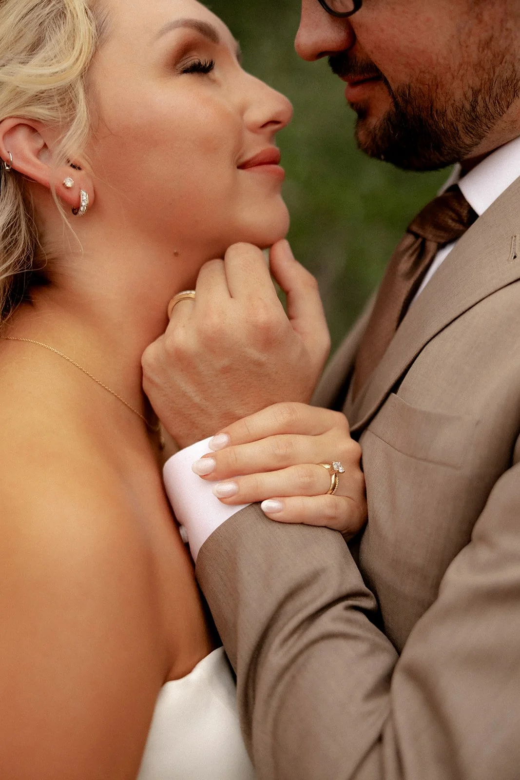 Close-up of bride and groom almost kissing, wedding jewelry and rings visible, at Browns Grove Sarasota