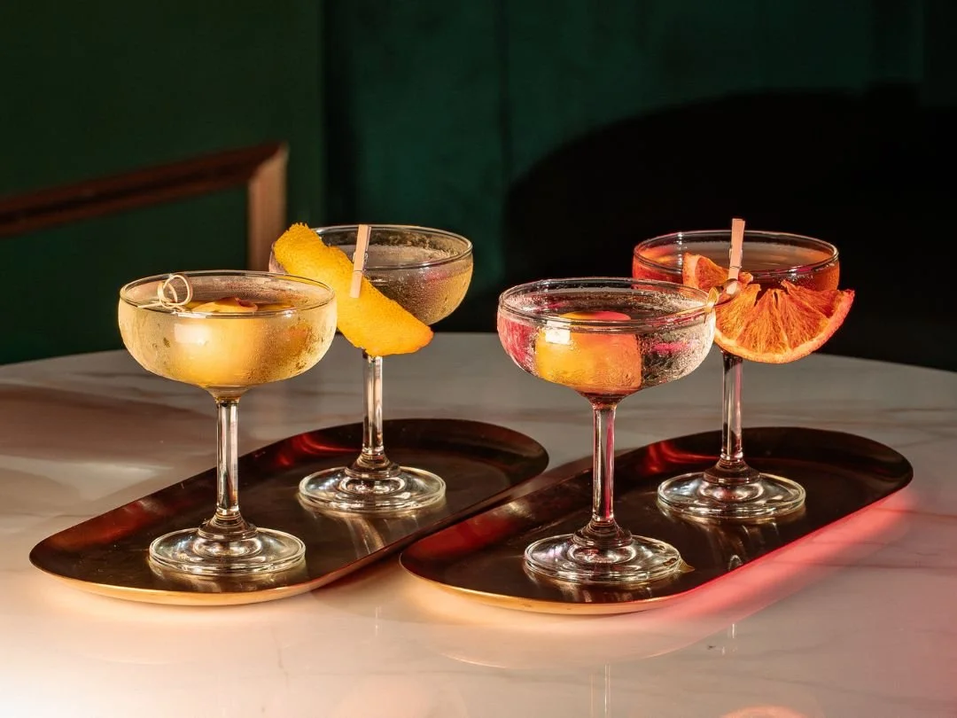 Tini martinis with citrus garnishes at Tipsy Flamingo, a cocktail bar in Downtown Miami.