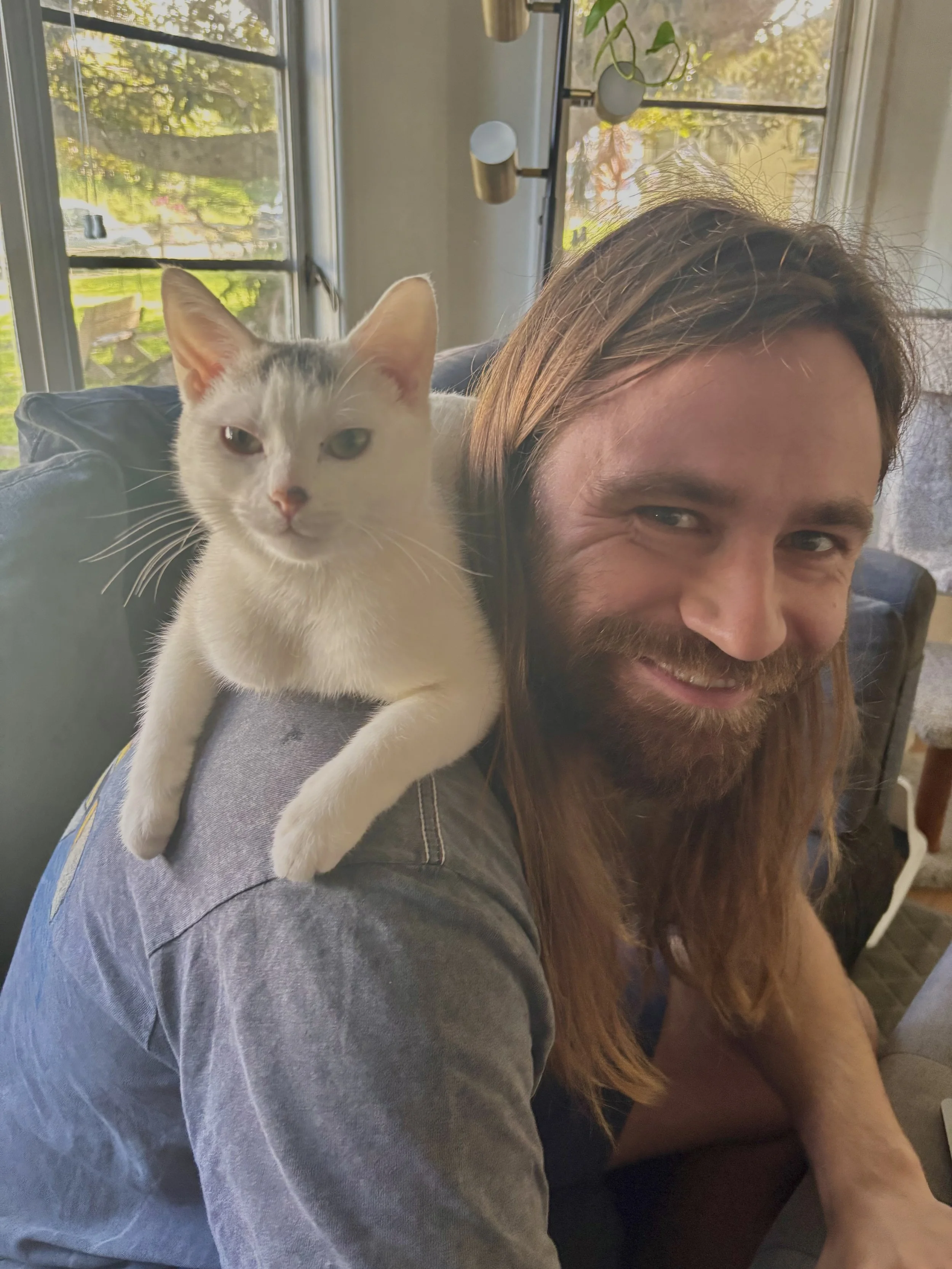 The owner of Zen Pet Care Solutions with a happy cat on a drop in visit in Ventura