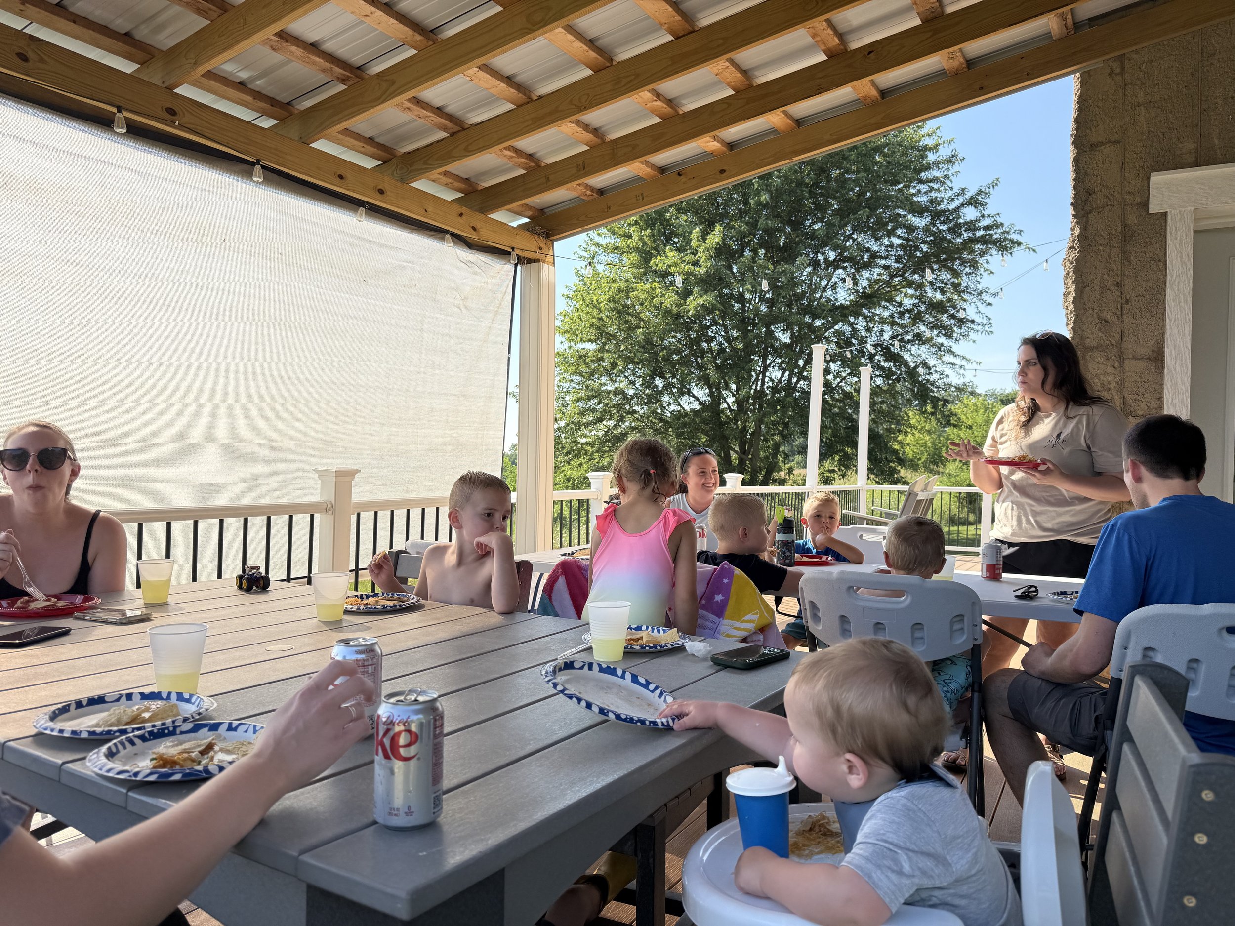 Dynamic Gathering, including children and adults, enjoying a meal