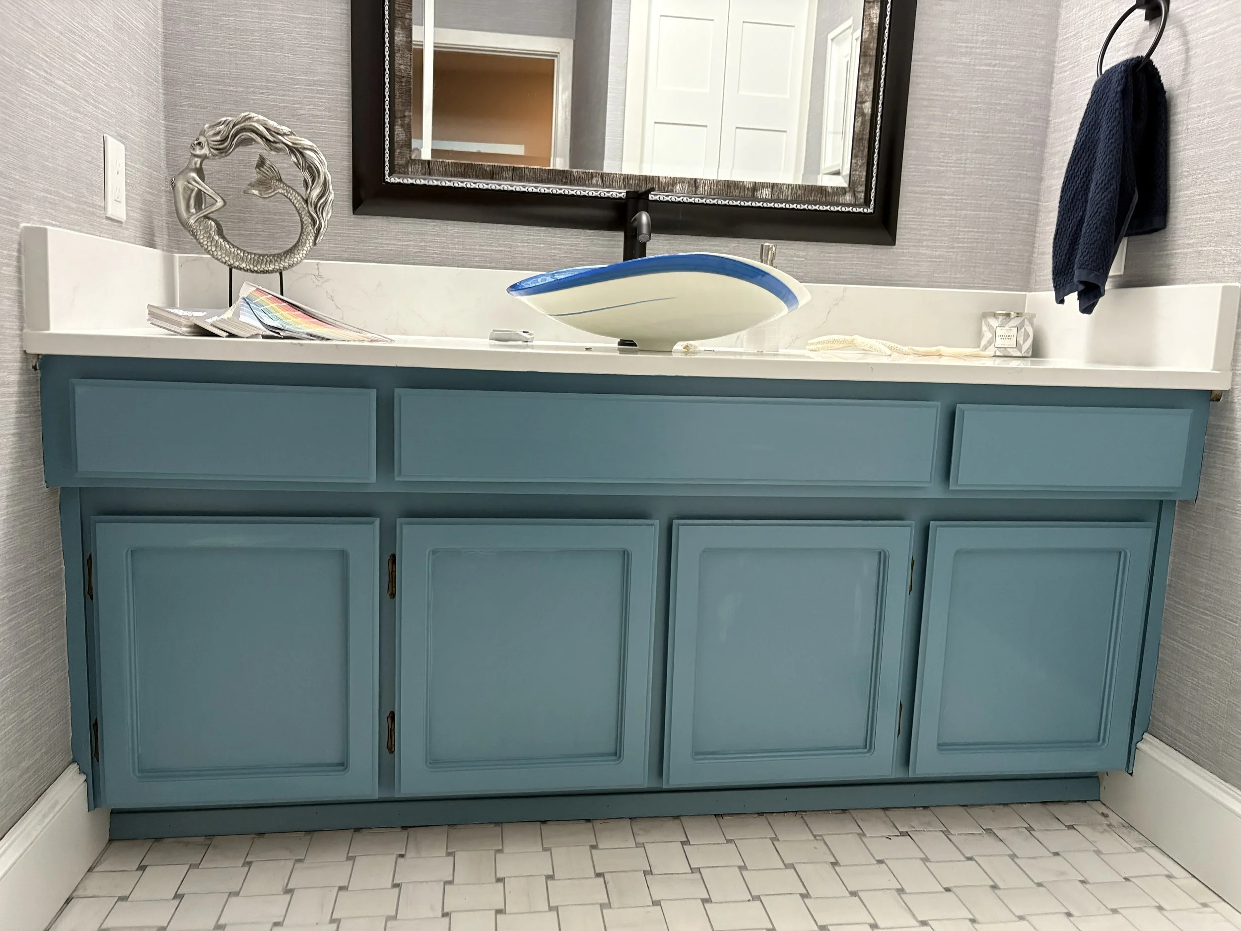Blue painted bathroom vanity cabinets with smooth professional finish