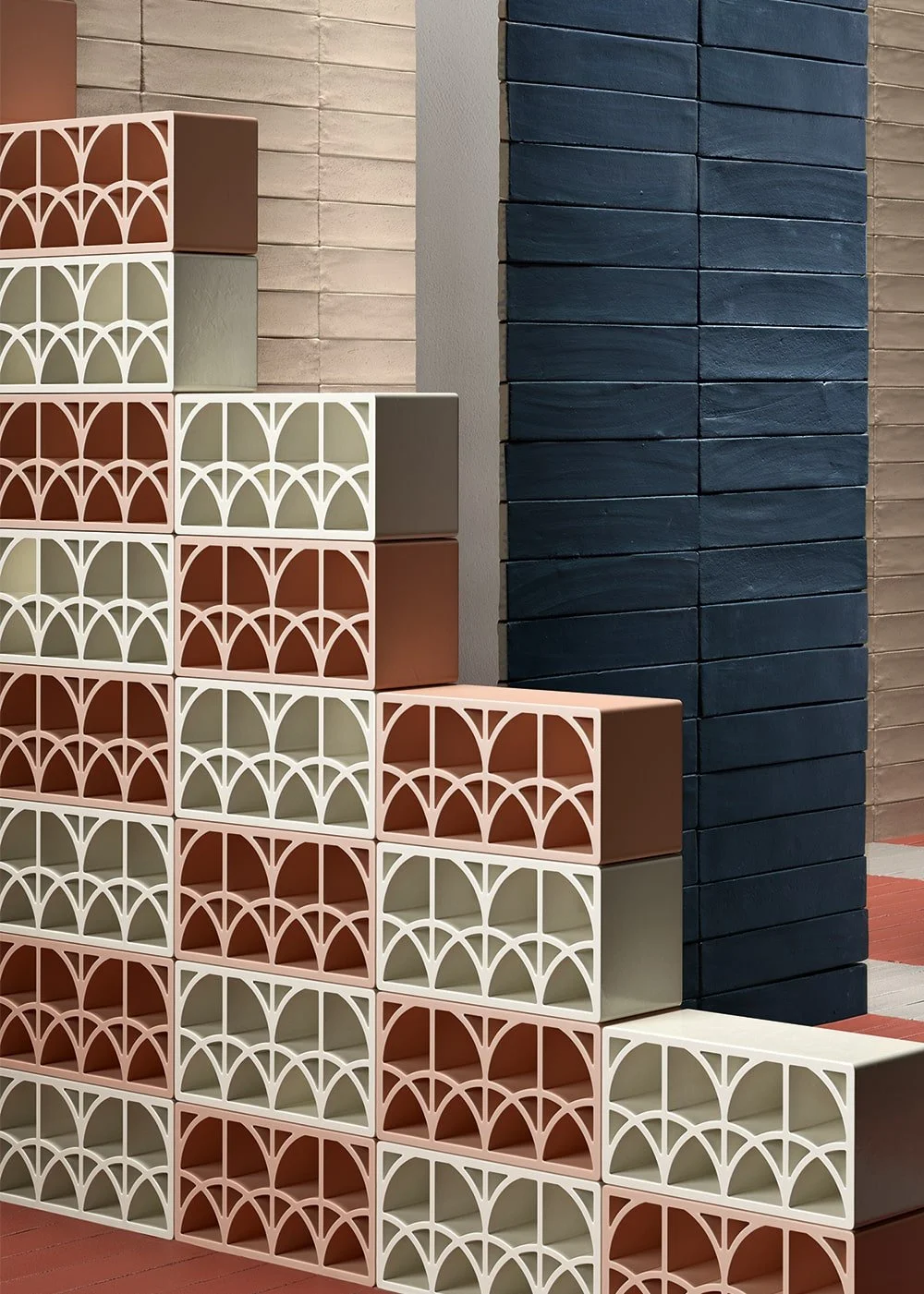 Stacked artisan terracotta tiles in warm and cool tones from Ispirare’s Split & Fornace collection, showcasing handcrafted texture and vertical installation.