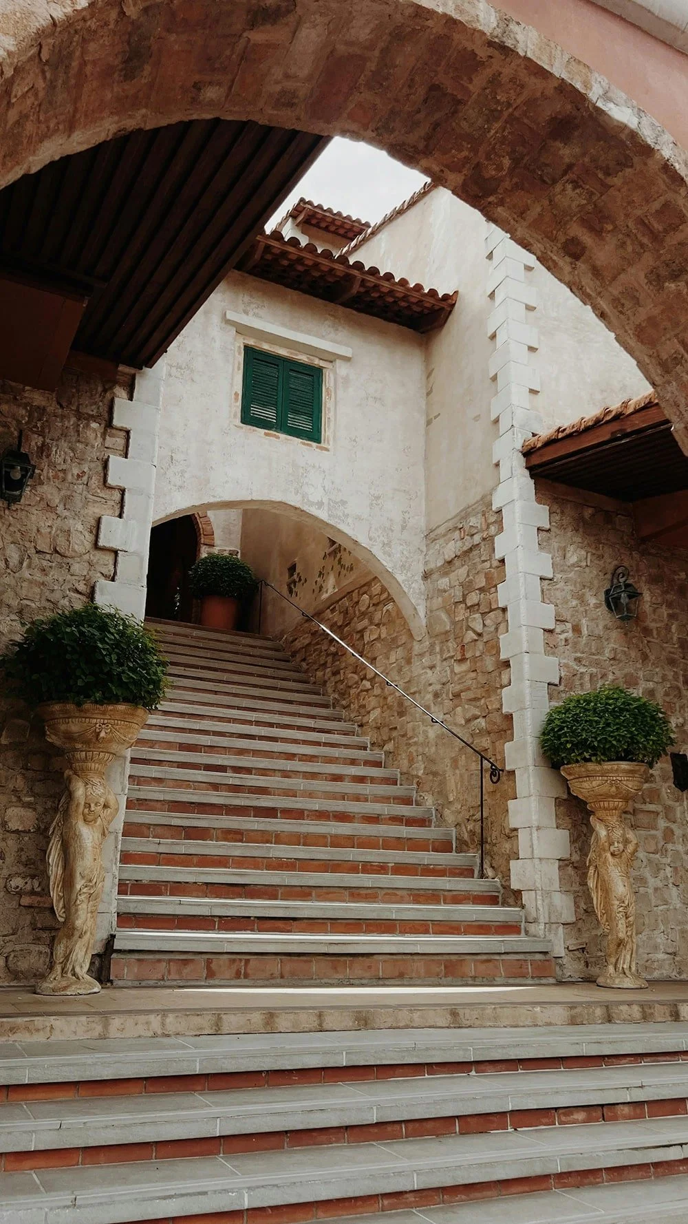 Arched stone staircase in a historic Italian architectural setting