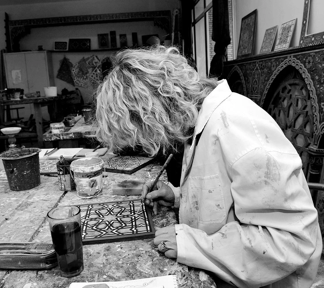 Italian artisan shaping ceramic tile by hand in a traditional workshop