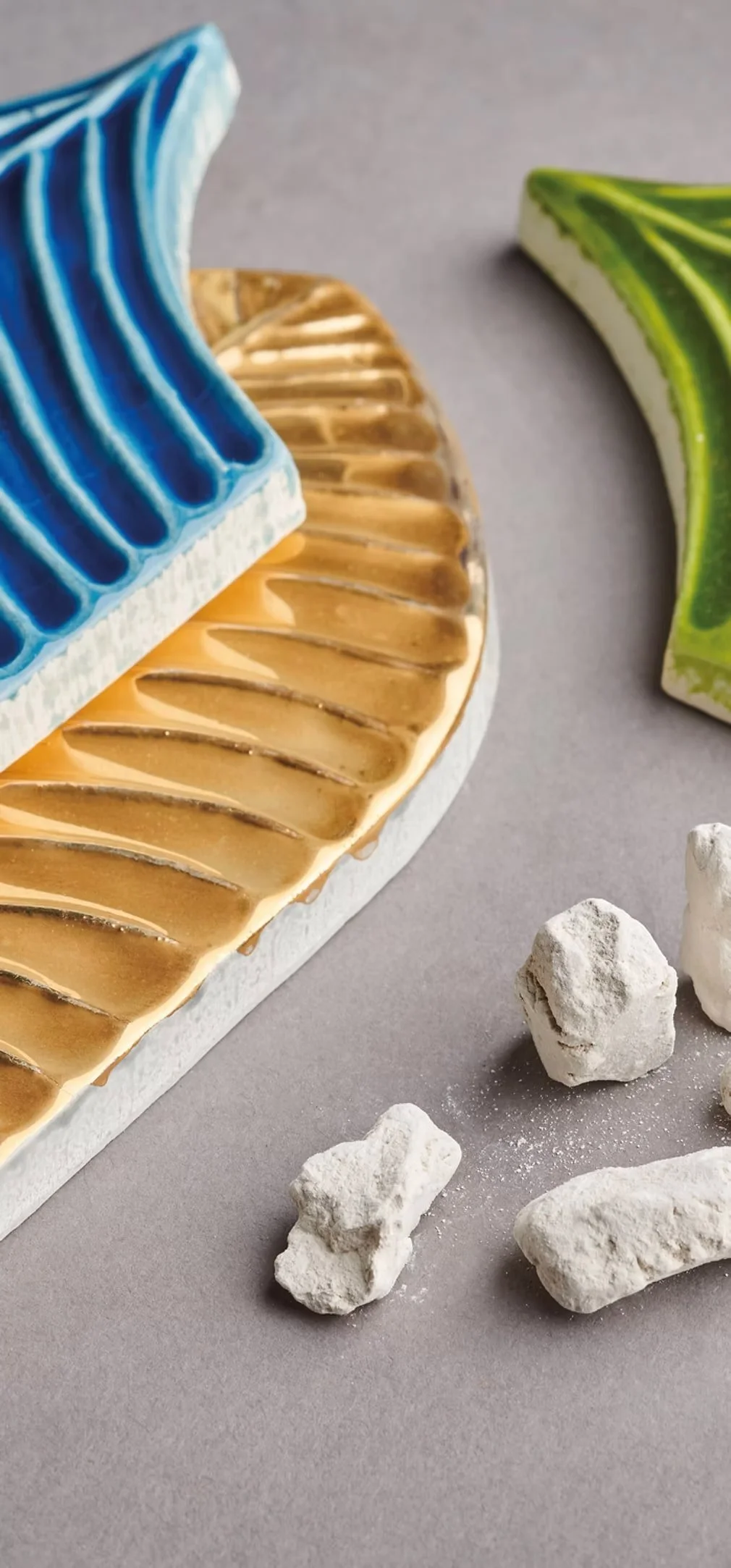 Calathea Metamorphosis feather-shaped handmade Italian tile from the Ispirare collection displayed in sculptural form