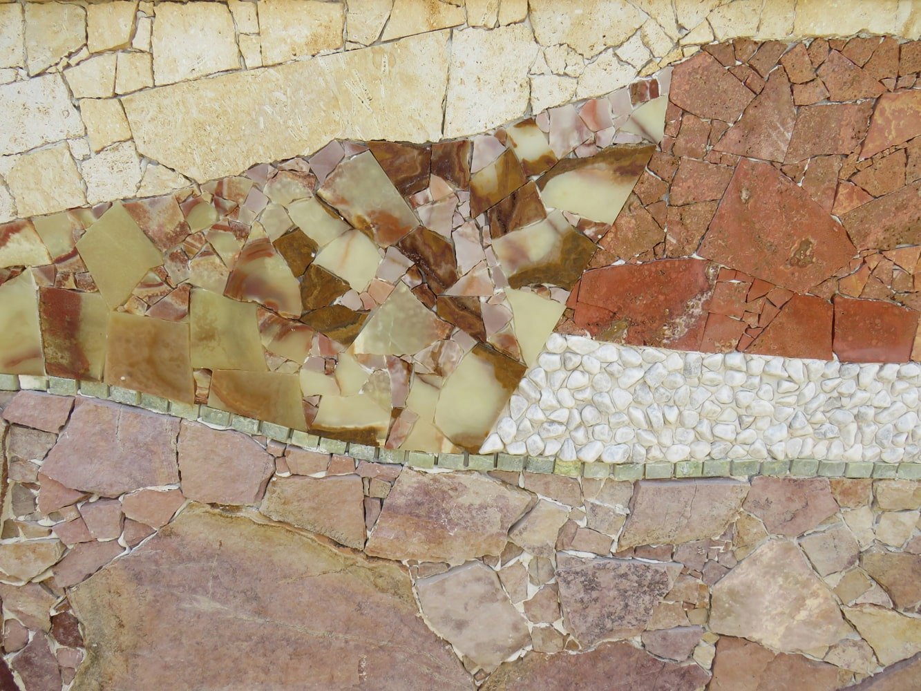 Layered natural stone and ceramic material samples arranged in a tonal composition