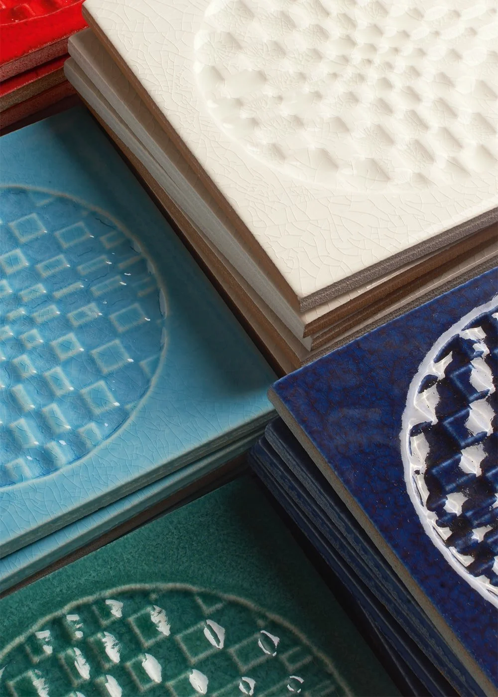 Città di Faenza tile detail showcasing traditional relief motifs in modern color.