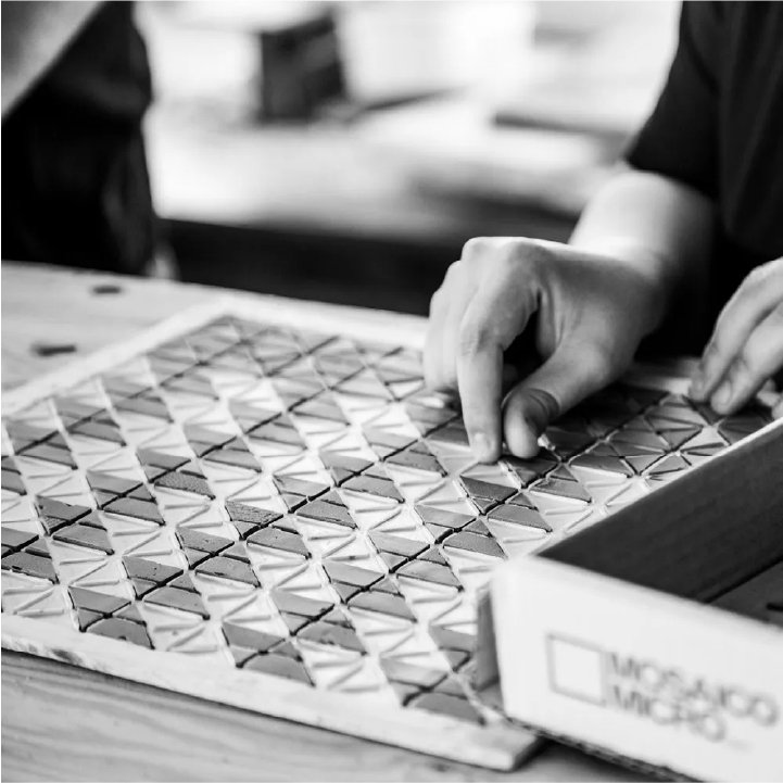 Artisan handcrafting geometric tile patterns