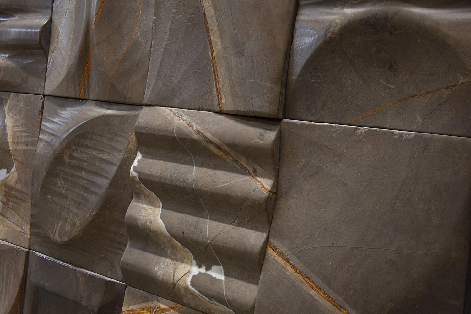 Natural Gris Corten stone tile featuring dimensional carved relief and architectural character