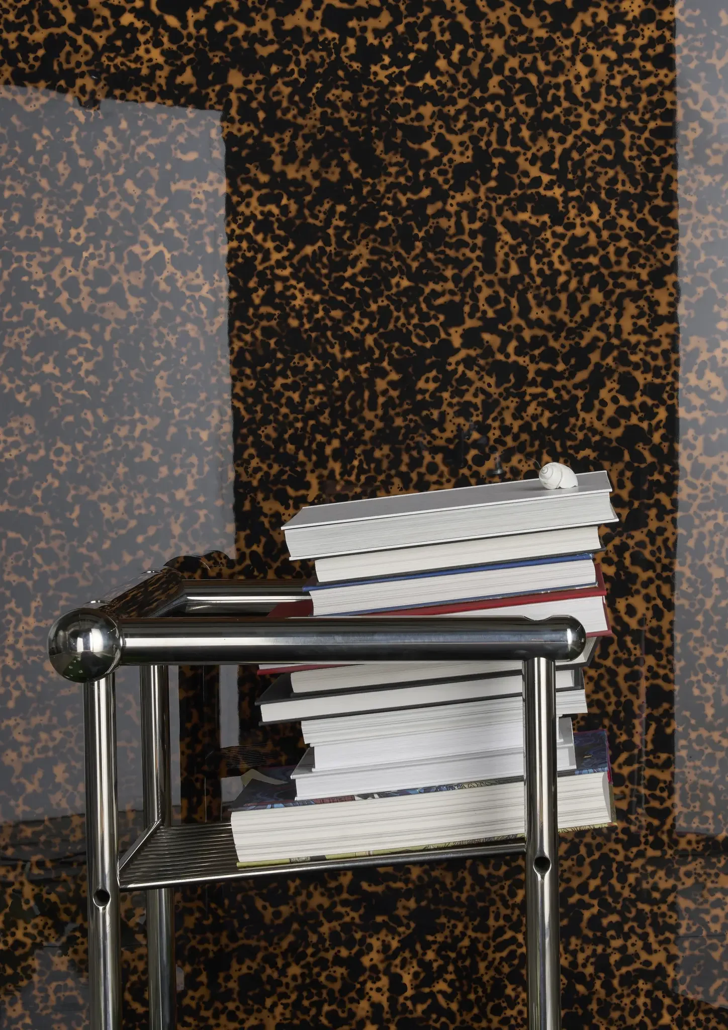 Tortuga glossy porcelain tile installed in a luxury interior with layered tortoiseshell-inspired patterning in amber and espresso tones