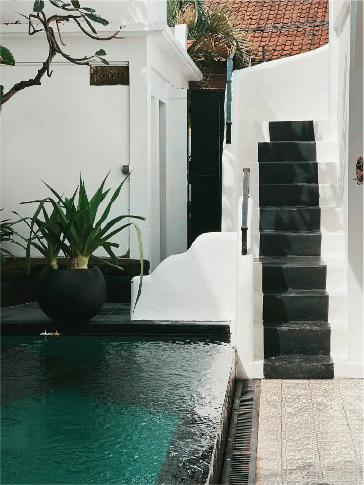 Mediterranean courtyard with emerald pool and white stucco