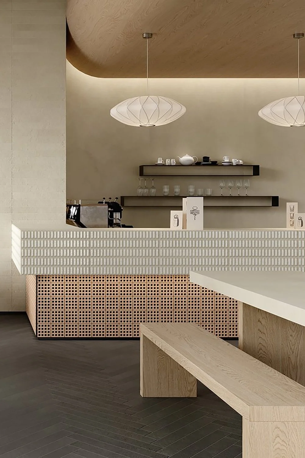 Soft neutral tile flooring in a minimalist cafe setting from Ispirare Arialuce Petruse.