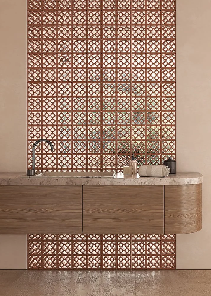 Terracotta Split Circle breeze block wall by Ispirare forming a sculptural bathroom divider with handcrafted lattice tiles and warm modern interior design.