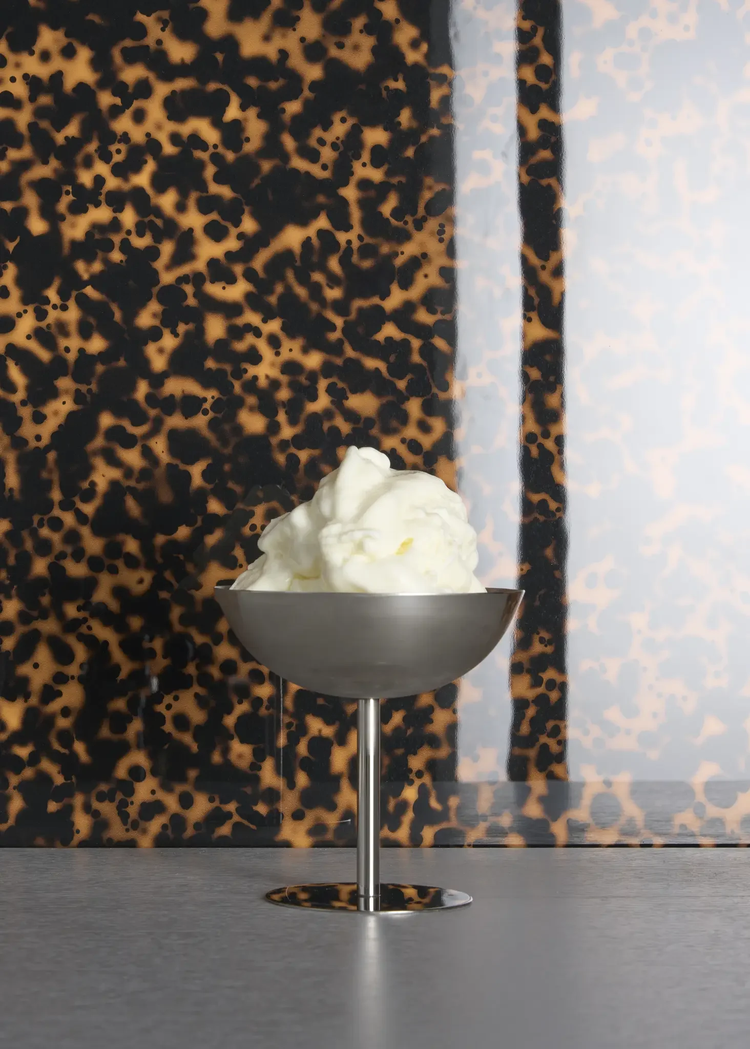 Tortuga glossy porcelain tile with tortoiseshell-inspired design in rich caramel and dark brown tones with Art Deco character