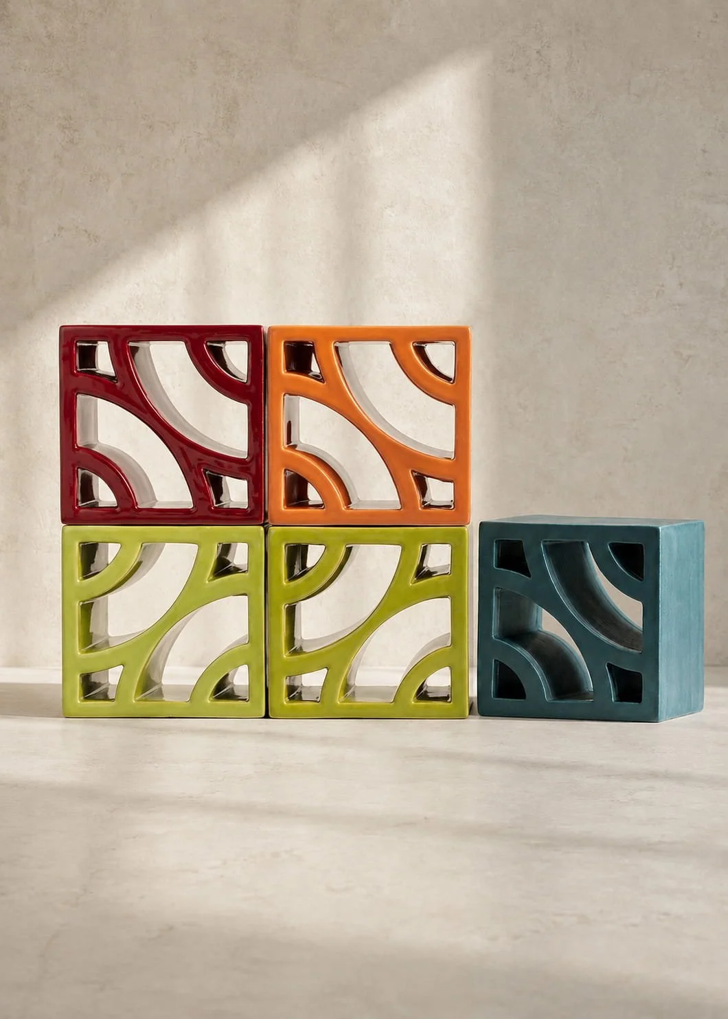 Split Blend Deco terracotta breeze block wall featuring geometric louvre forms and filtered natural light